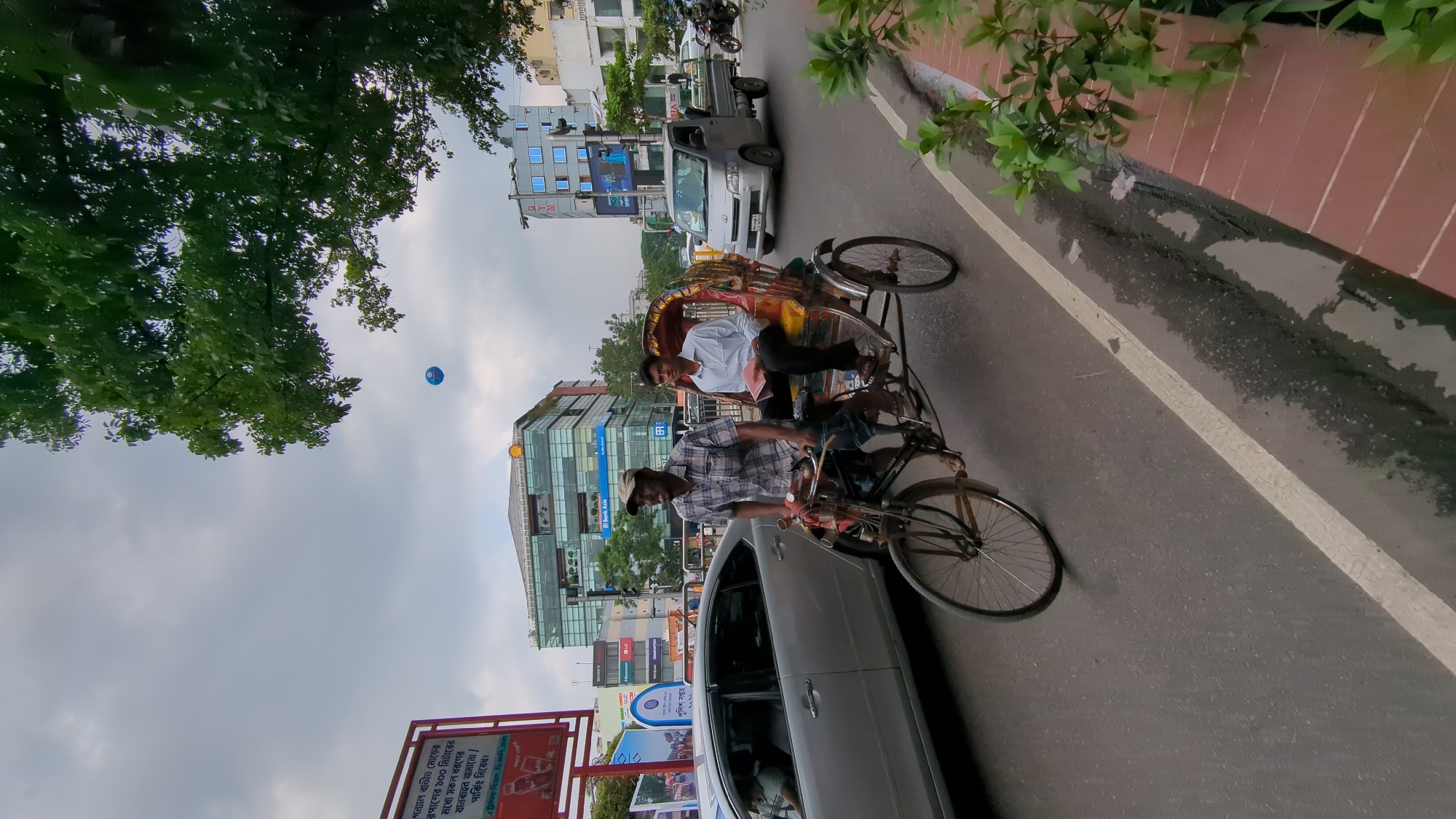 Morning traffic flows through Dhaka streets amid urban activity