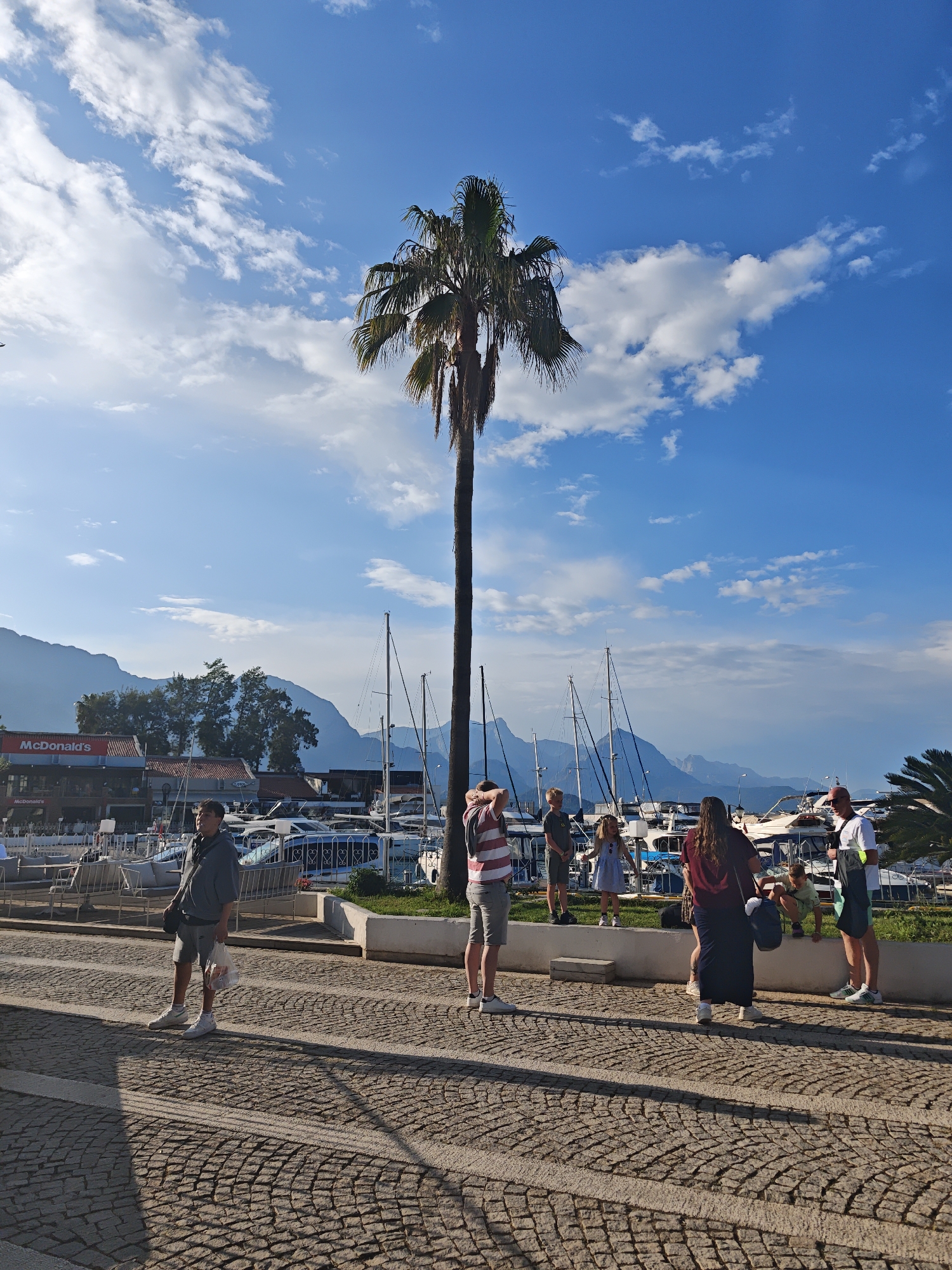 Tourist explores Kemer marina and shops during afternoon visit