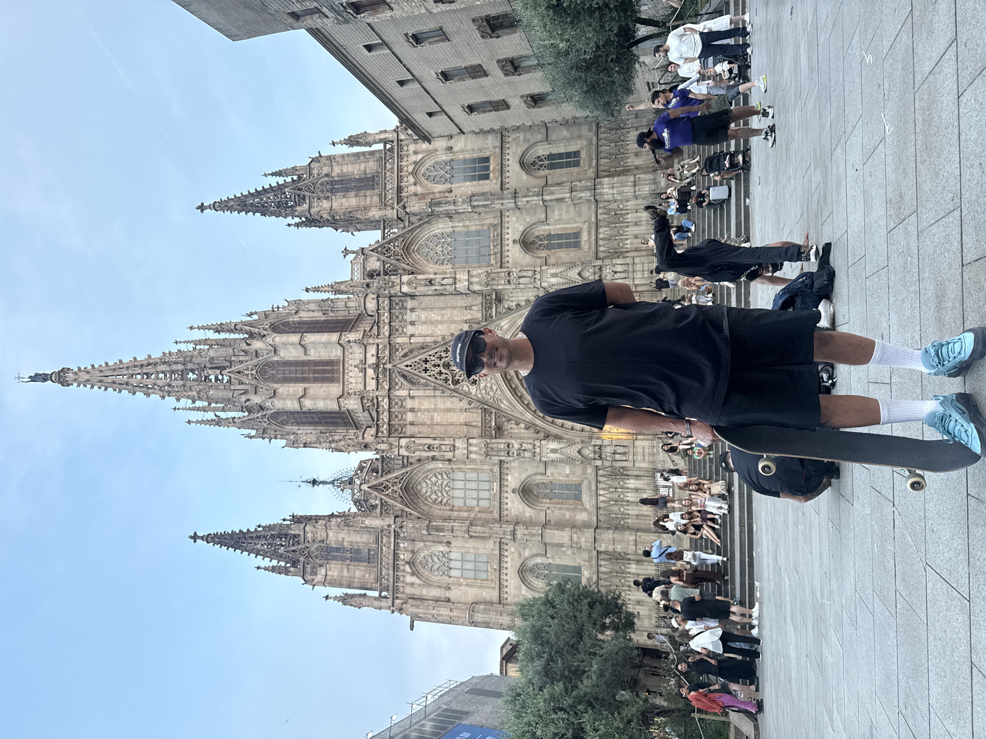 Evening street life unfolds around Barcelona Cathedral plaza