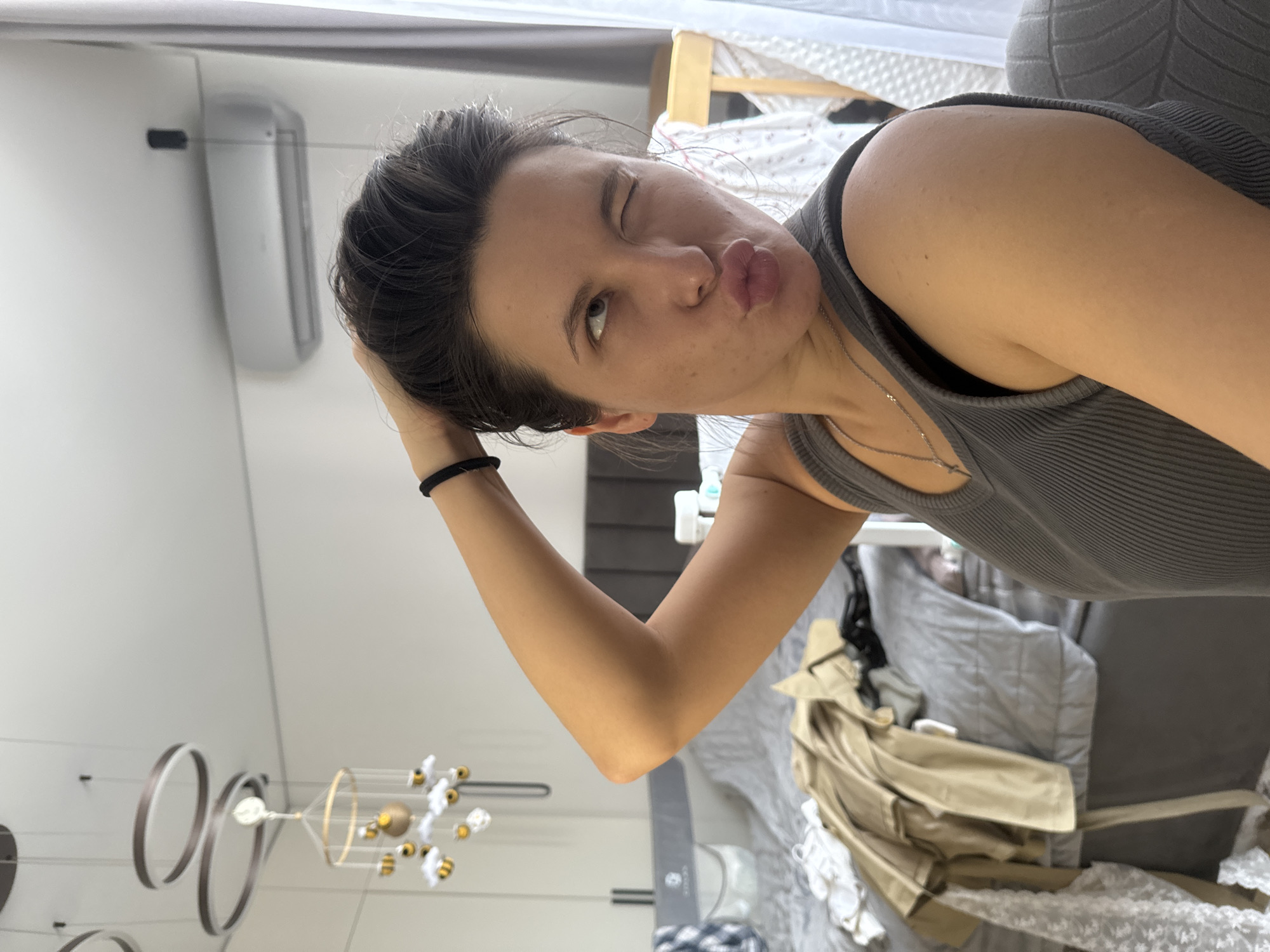 Woman takes selfies, applies makeup in Odintsovo bedroom