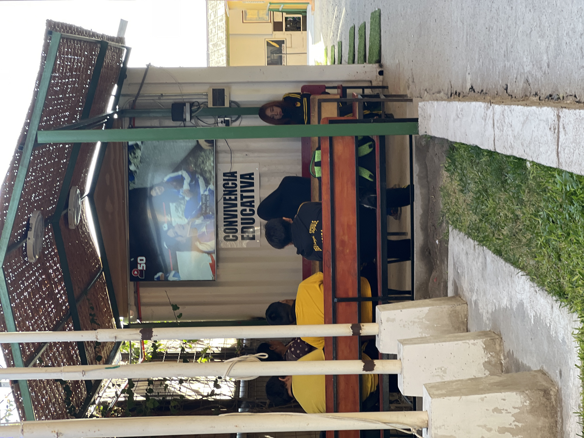 Young people gather at outdoor seating area in Arica