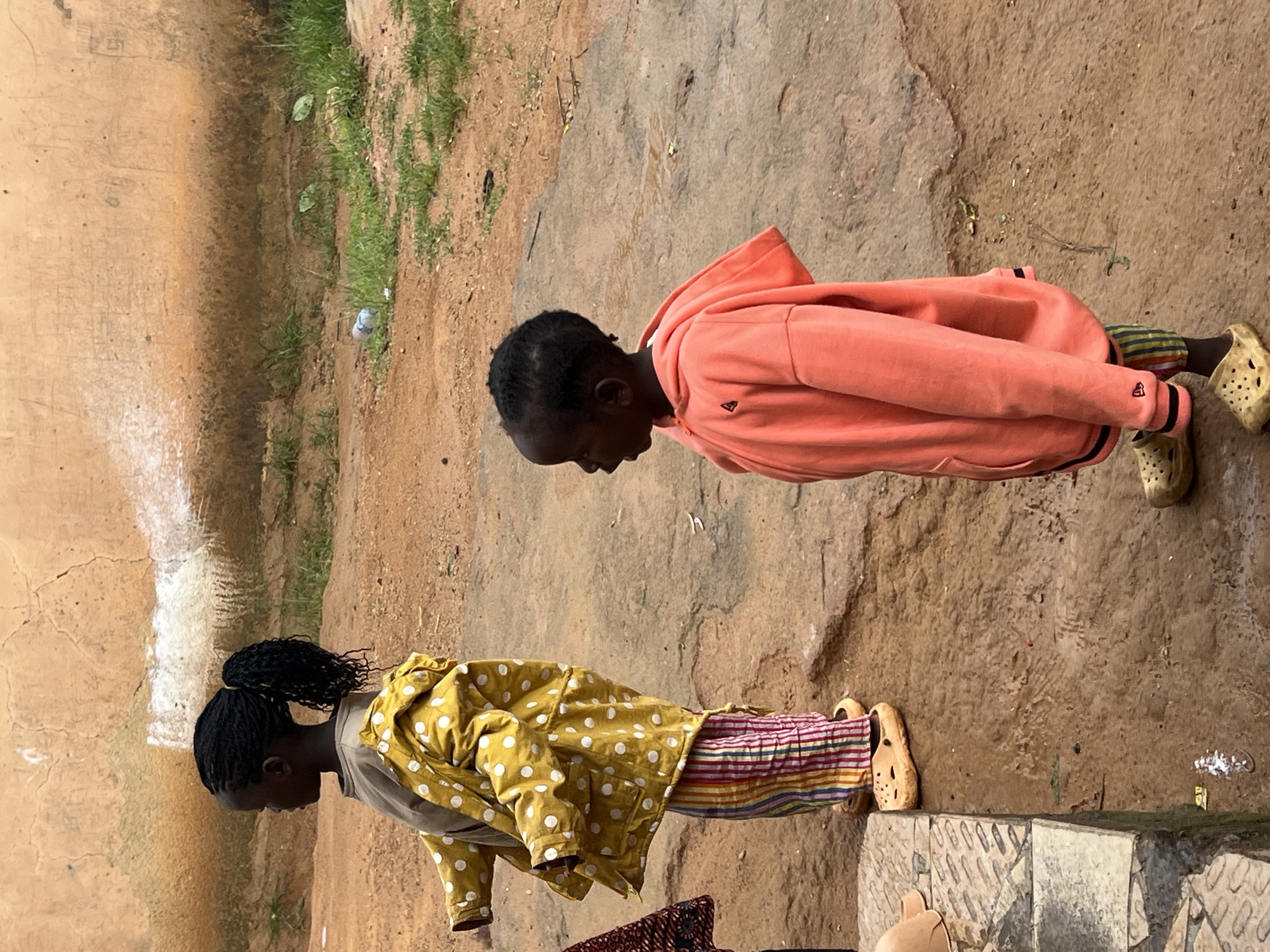 Kids playing outdoors in a residential yard in Jos, Nigeria