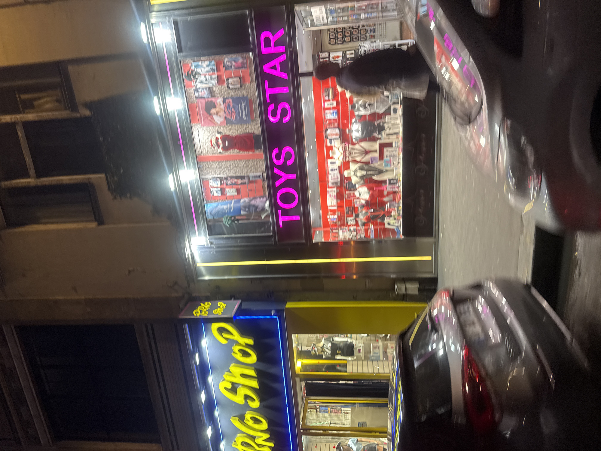Adult retail shops documented at night in Paris