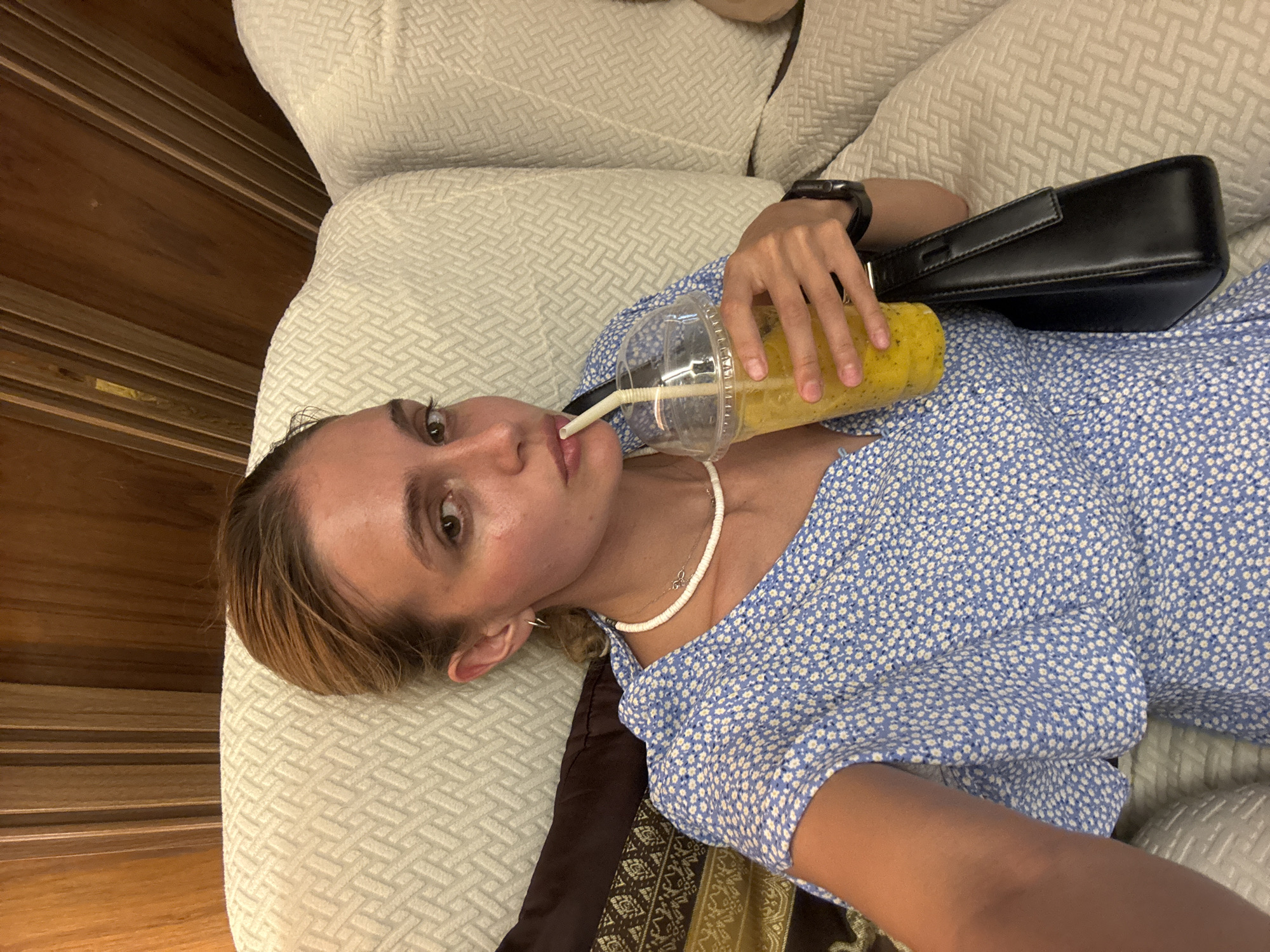 Woman relaxes with drink on sofa in Patong