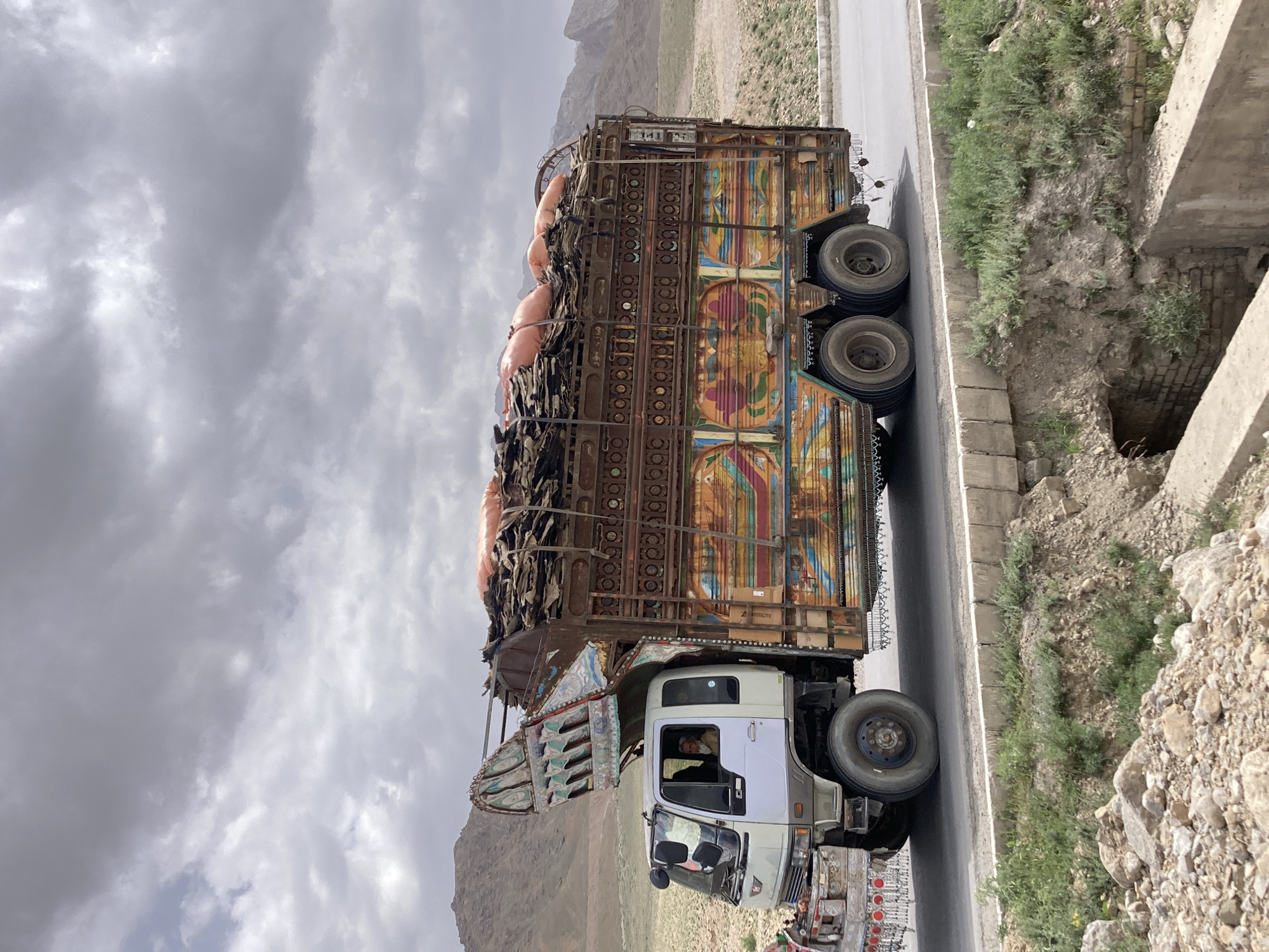 Decorated truck spotted carrying cargo on Pakistan mountain road