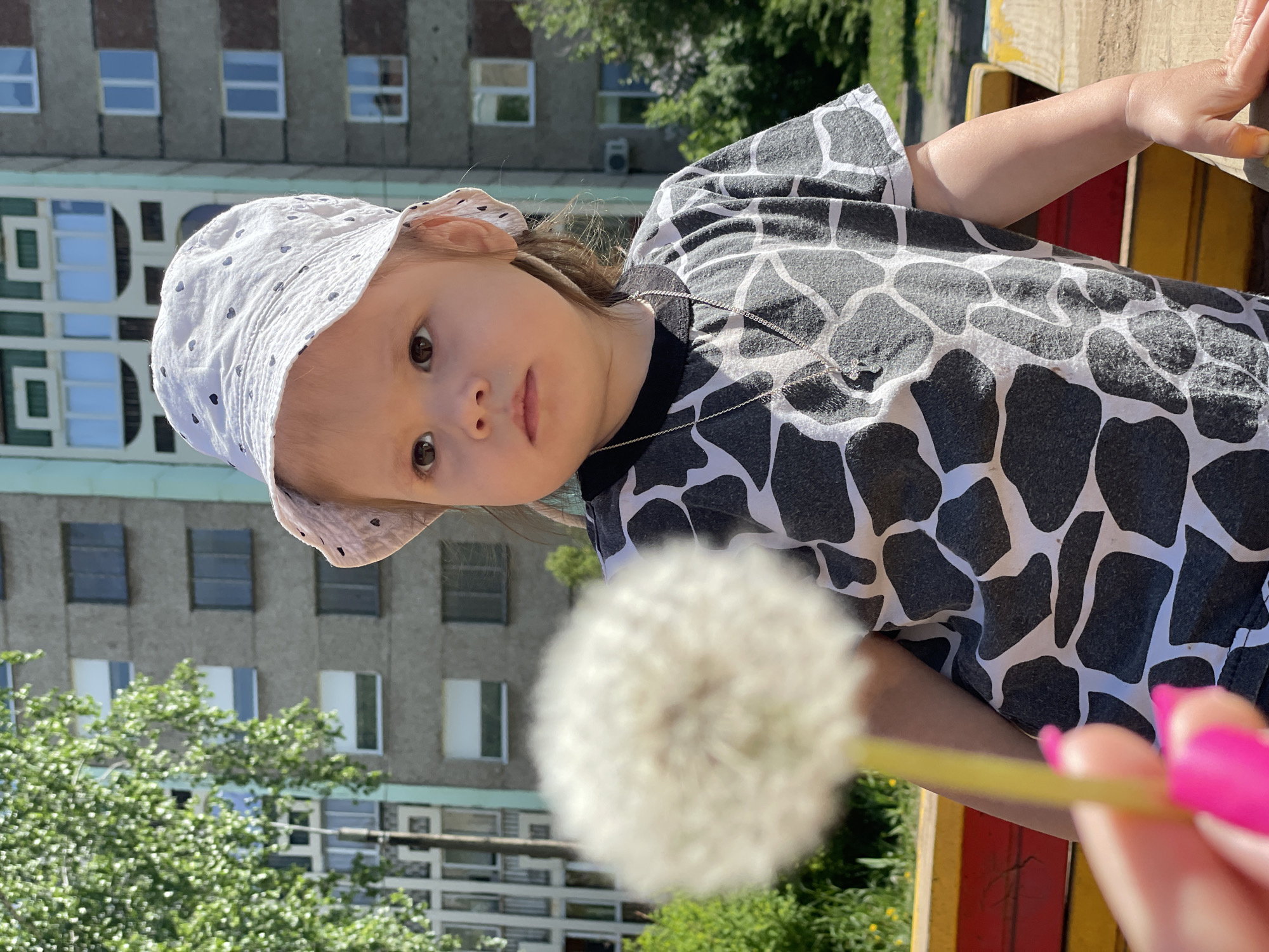 Mother and child play among dandelions in Izhevsk field