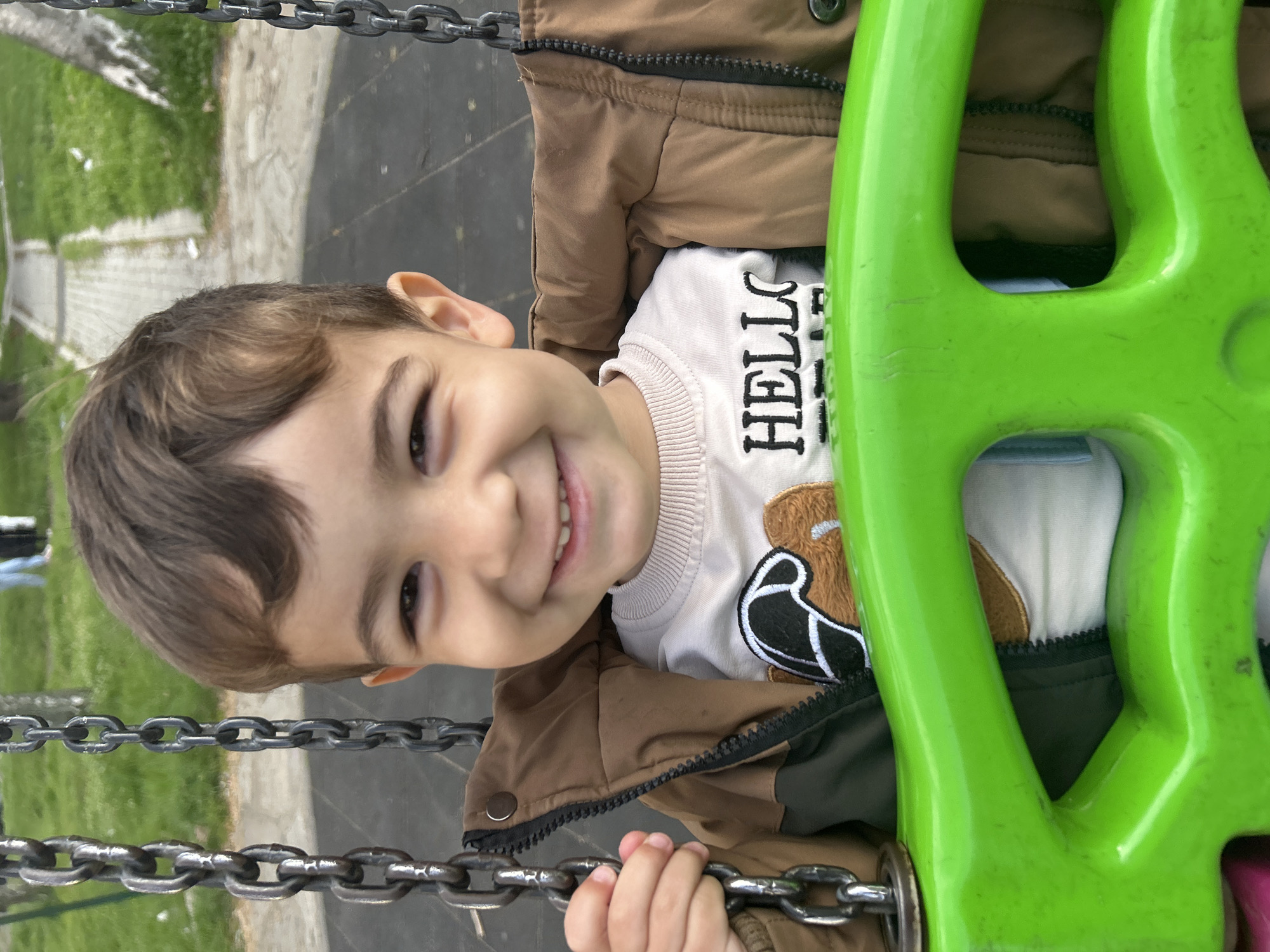 Child plays on swings at Kardzhali playground