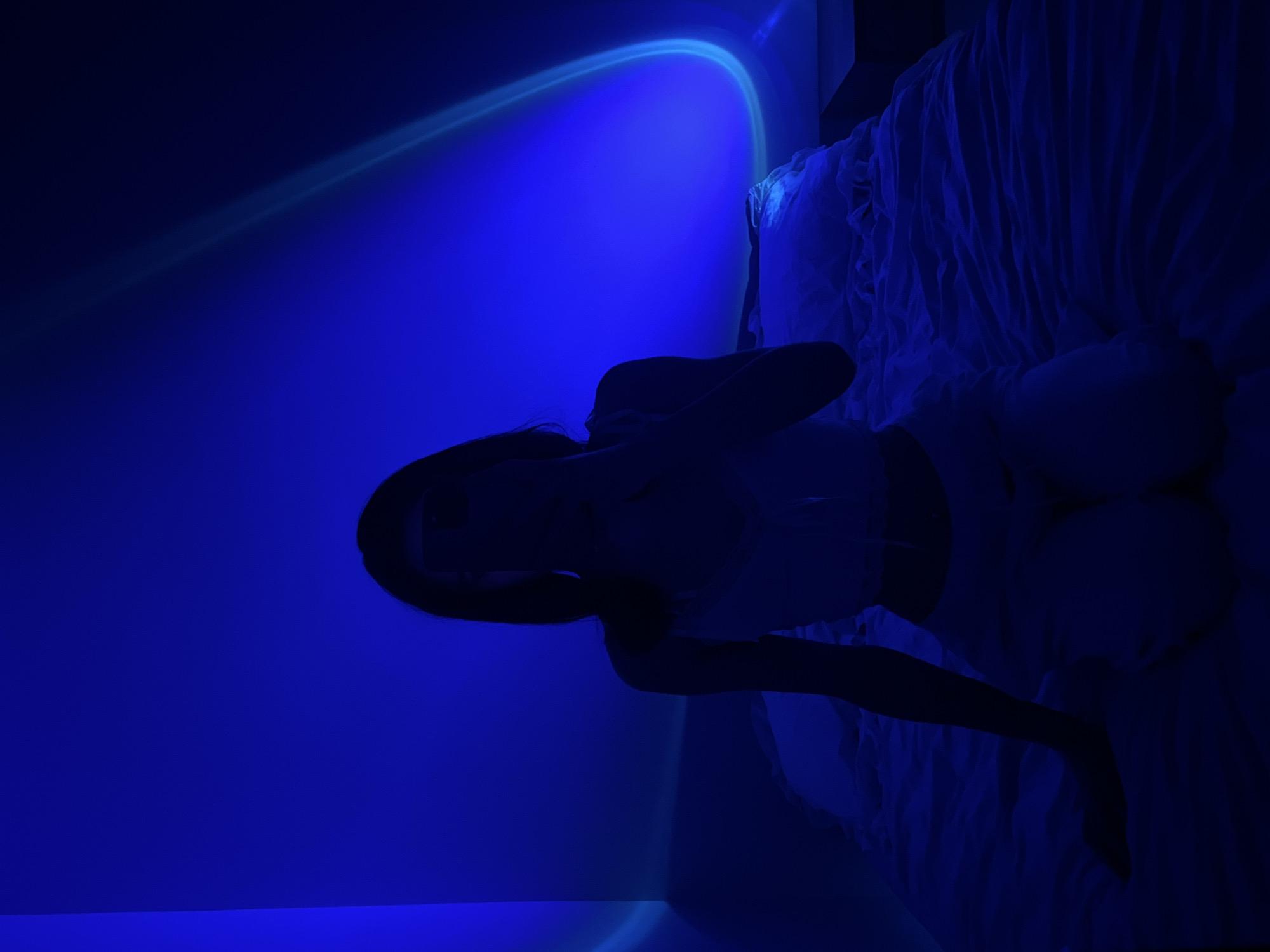 Blue-lit bedroom, phone in hand, quiet evening in Ternopil