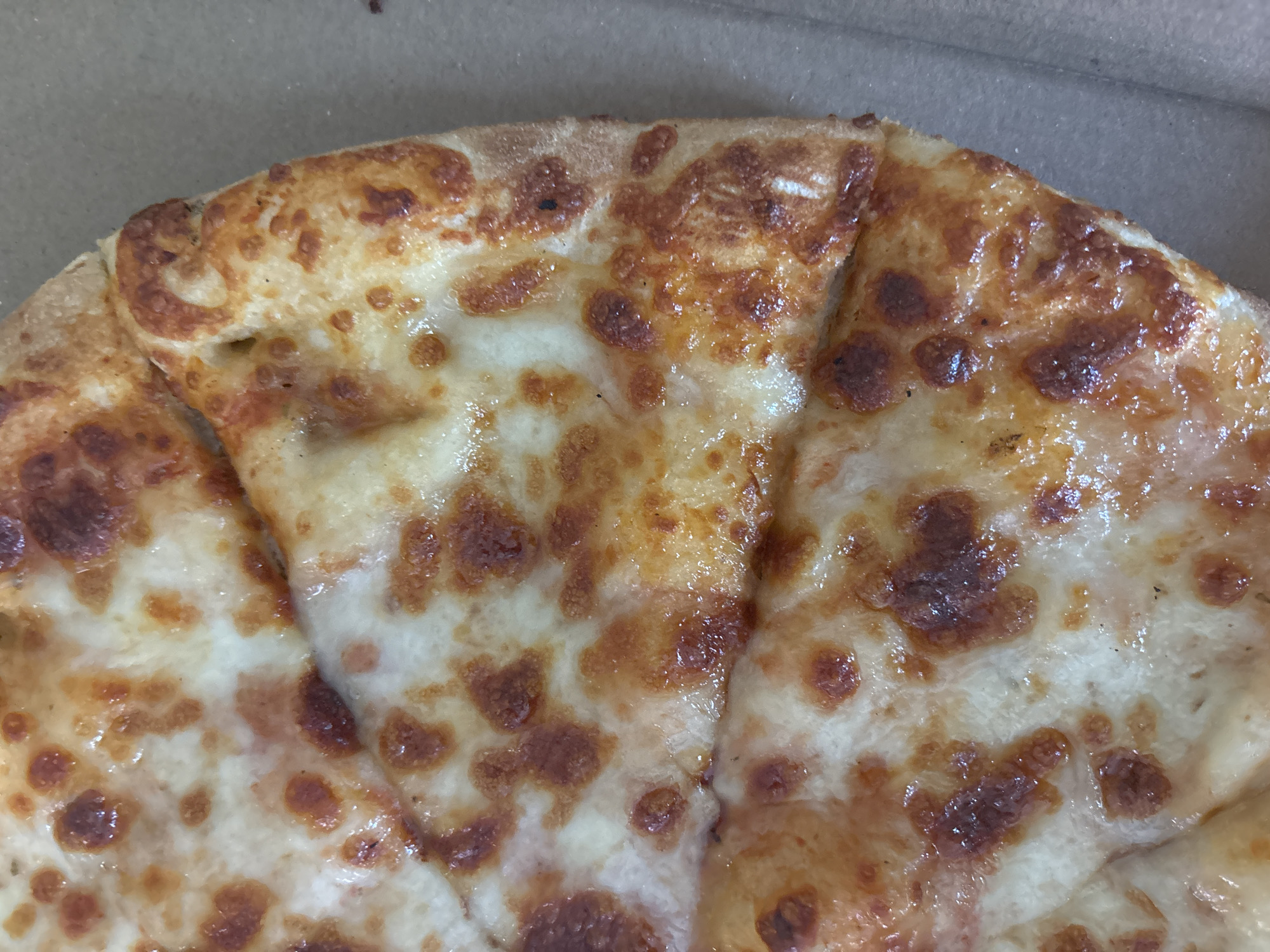Cheese pizza documented in cardboard box in Sofia