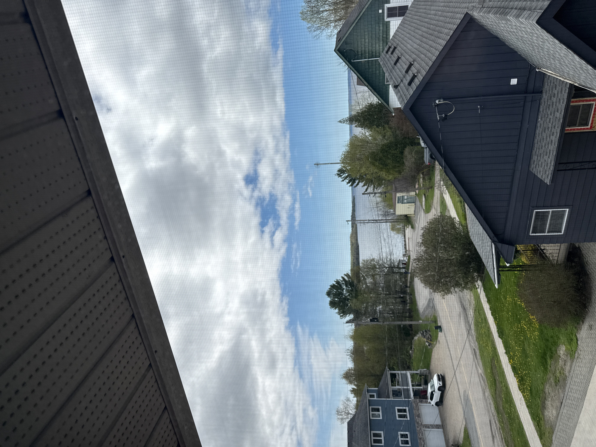 Waterfront view captured through window screen at residential location