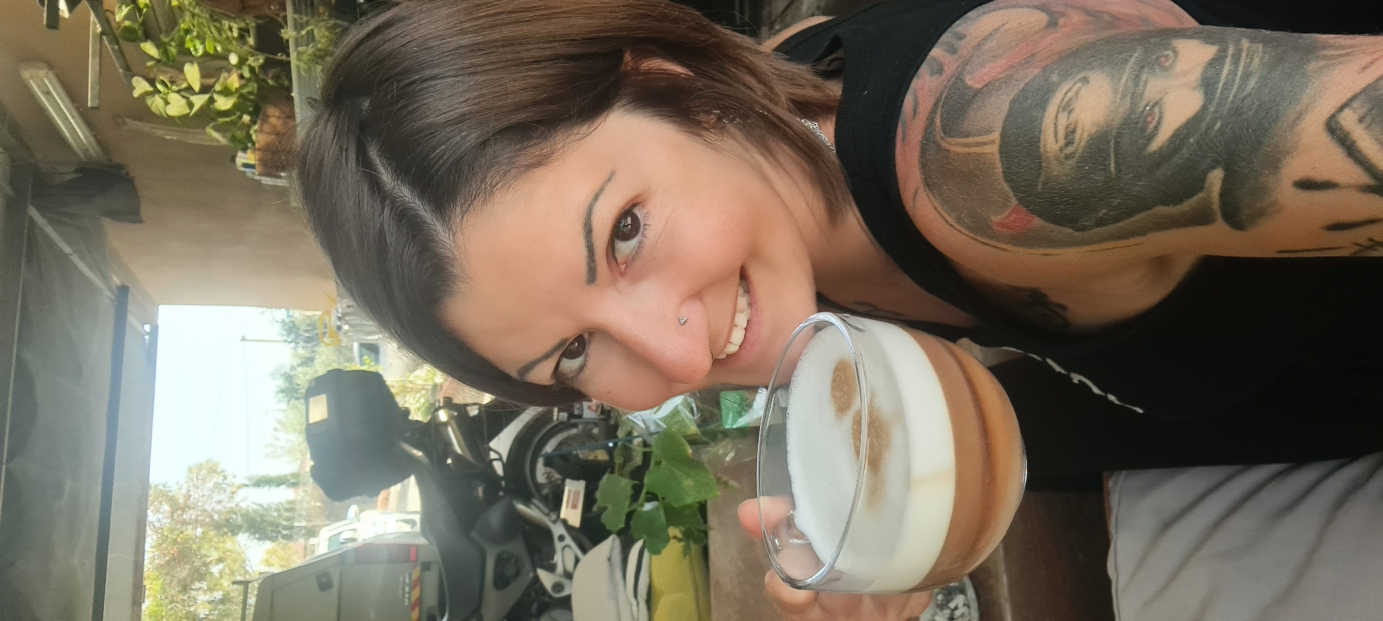 Woman enjoys layered coffee drink in Israeli regional area
