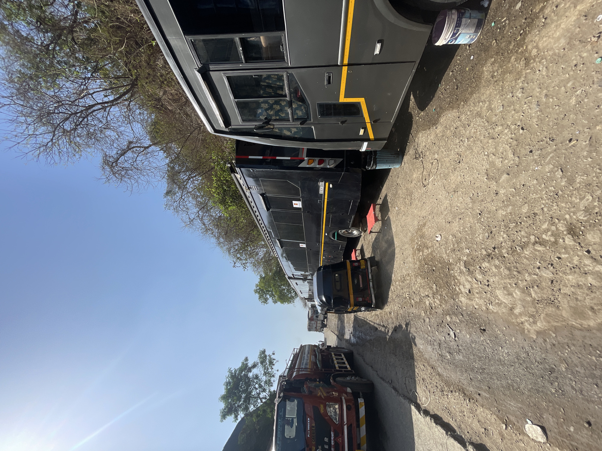 Buses with yellow stripes parked on Mumbai street