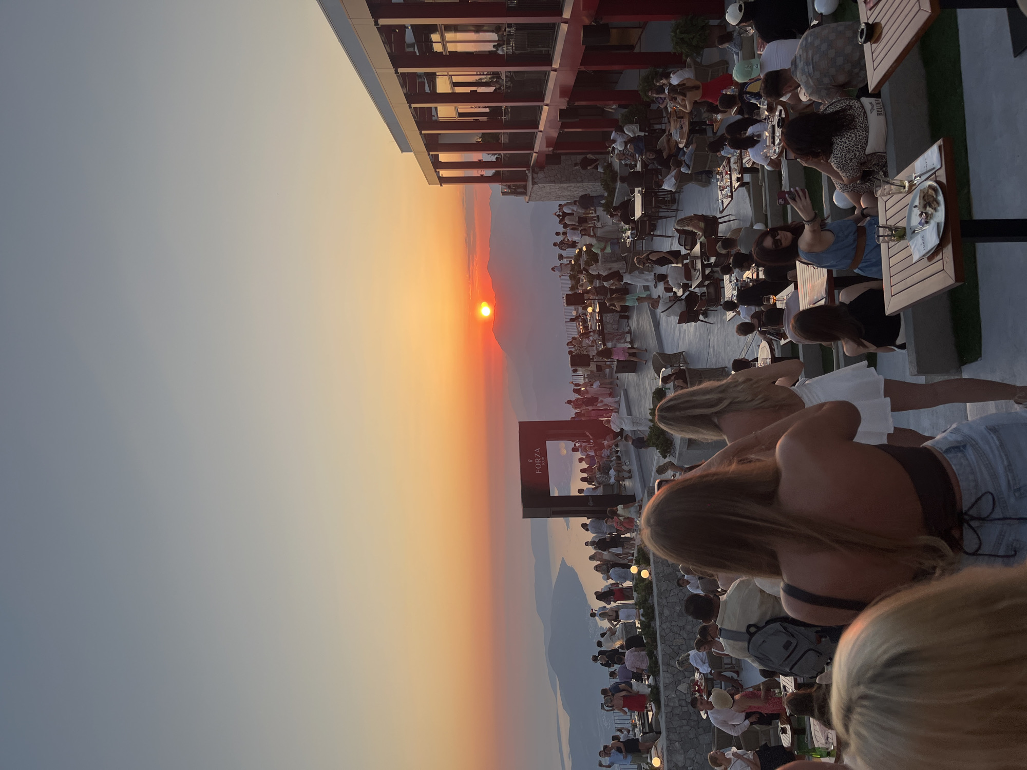 Sunset gathering at a hillside venue overlooking Montenegrin waters