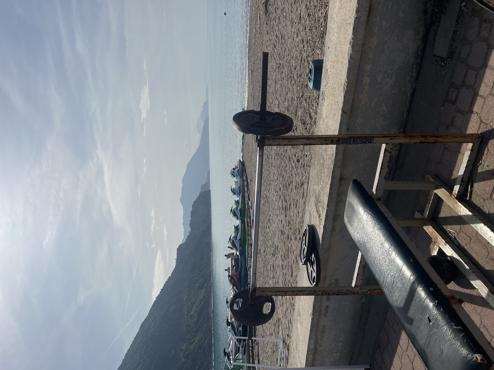 Rusty beach weightlifting bench spotted facing sea in Montenegro