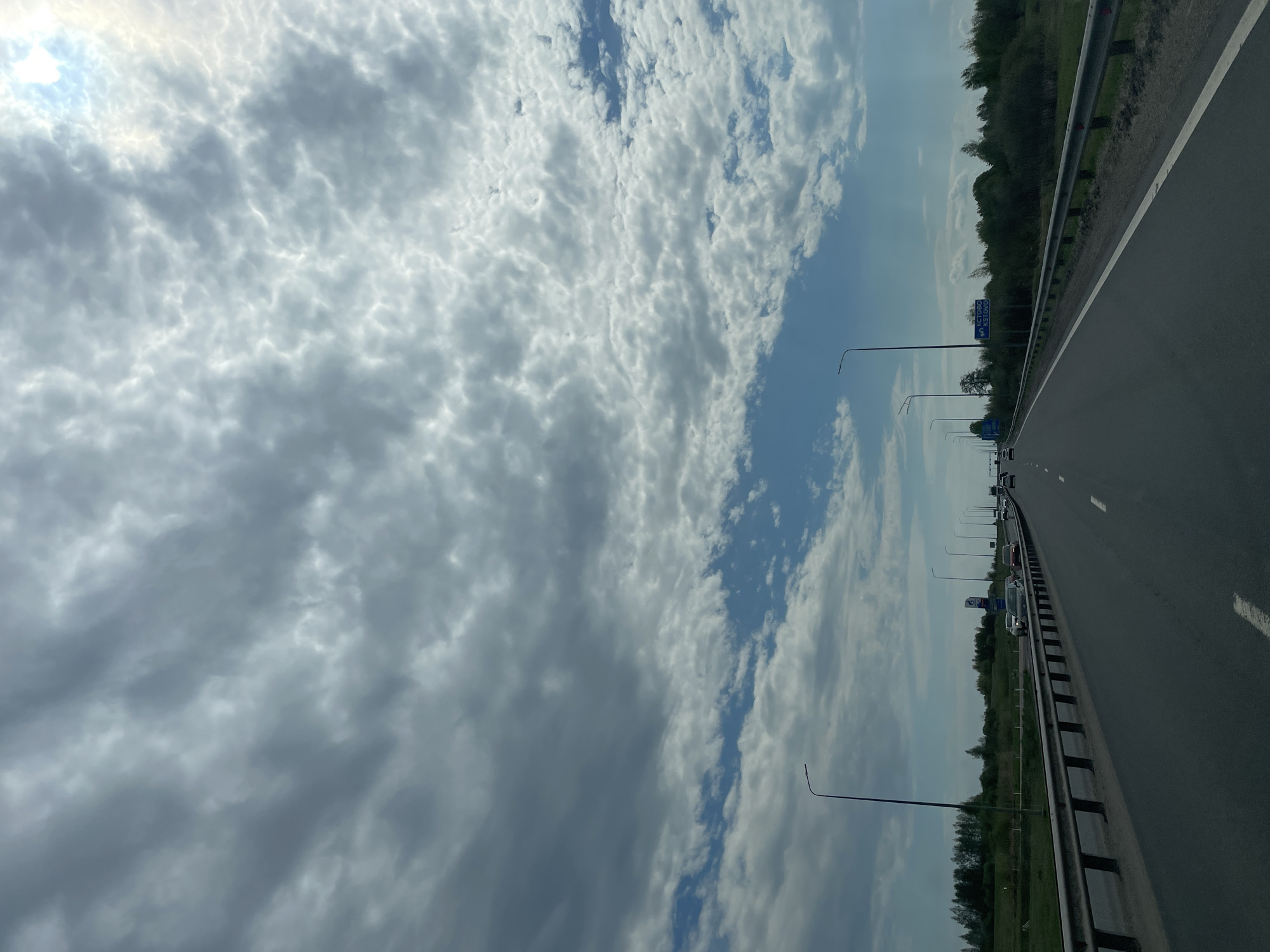 Highway scene documented with cloudy skies and infrastructure