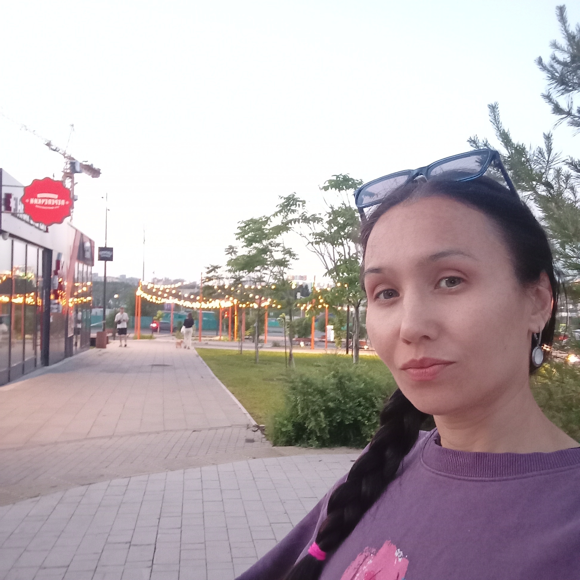 Woman takes selfie at twilight in Pervomaysky, Russia