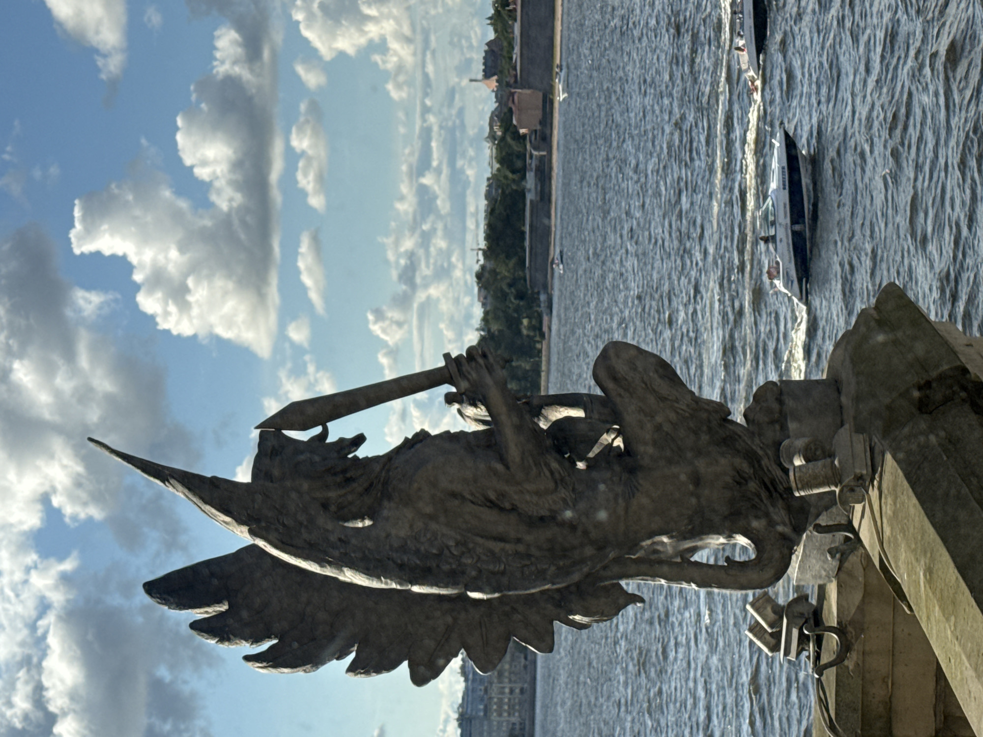 Stone griffin statue overlooking Saint Petersburg's historic cityscape