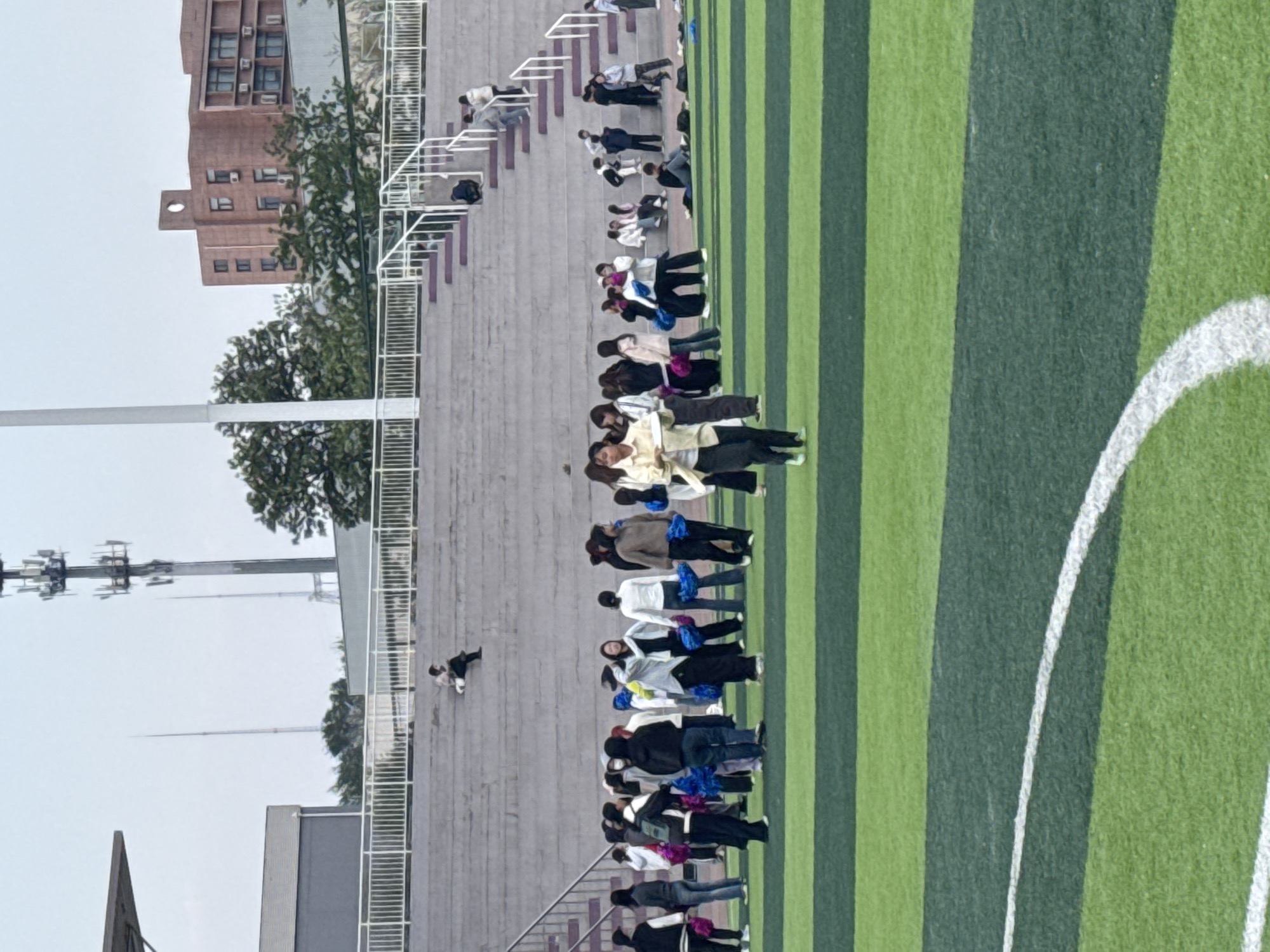 Group gathers at Linghe stadium, women observe sky