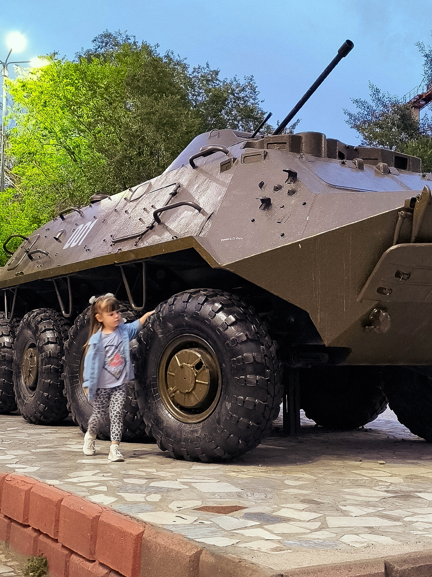 Military vehicle on public display in Qarağandı at sunset