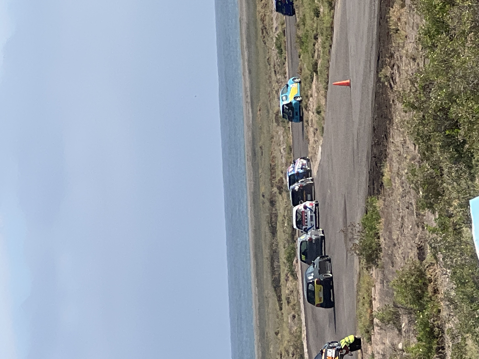 Race day at Arica's coastal track, cars and flags everywhere
