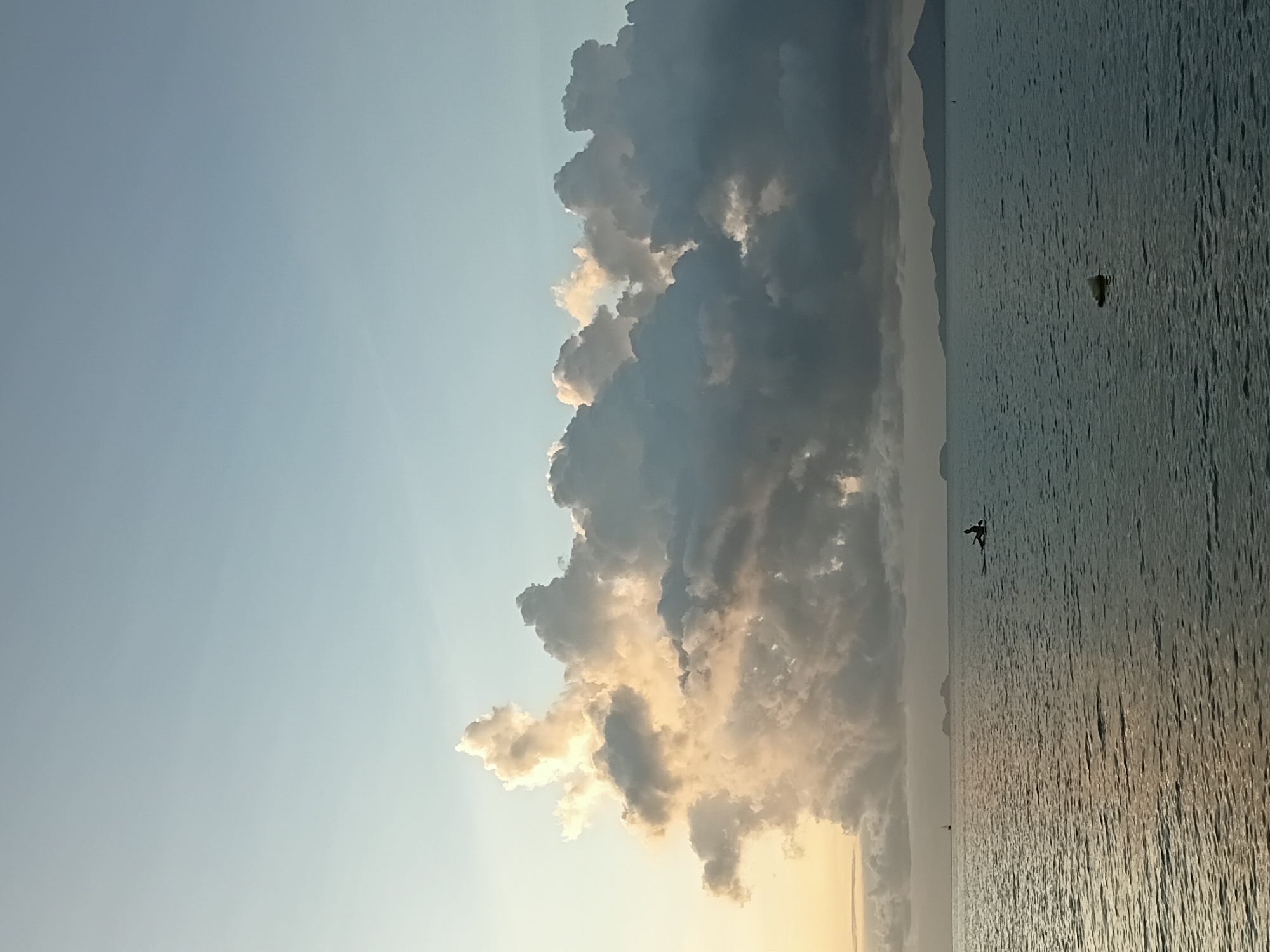 Golden hour at Baan Bang Rak — coast, clouds, and calm water