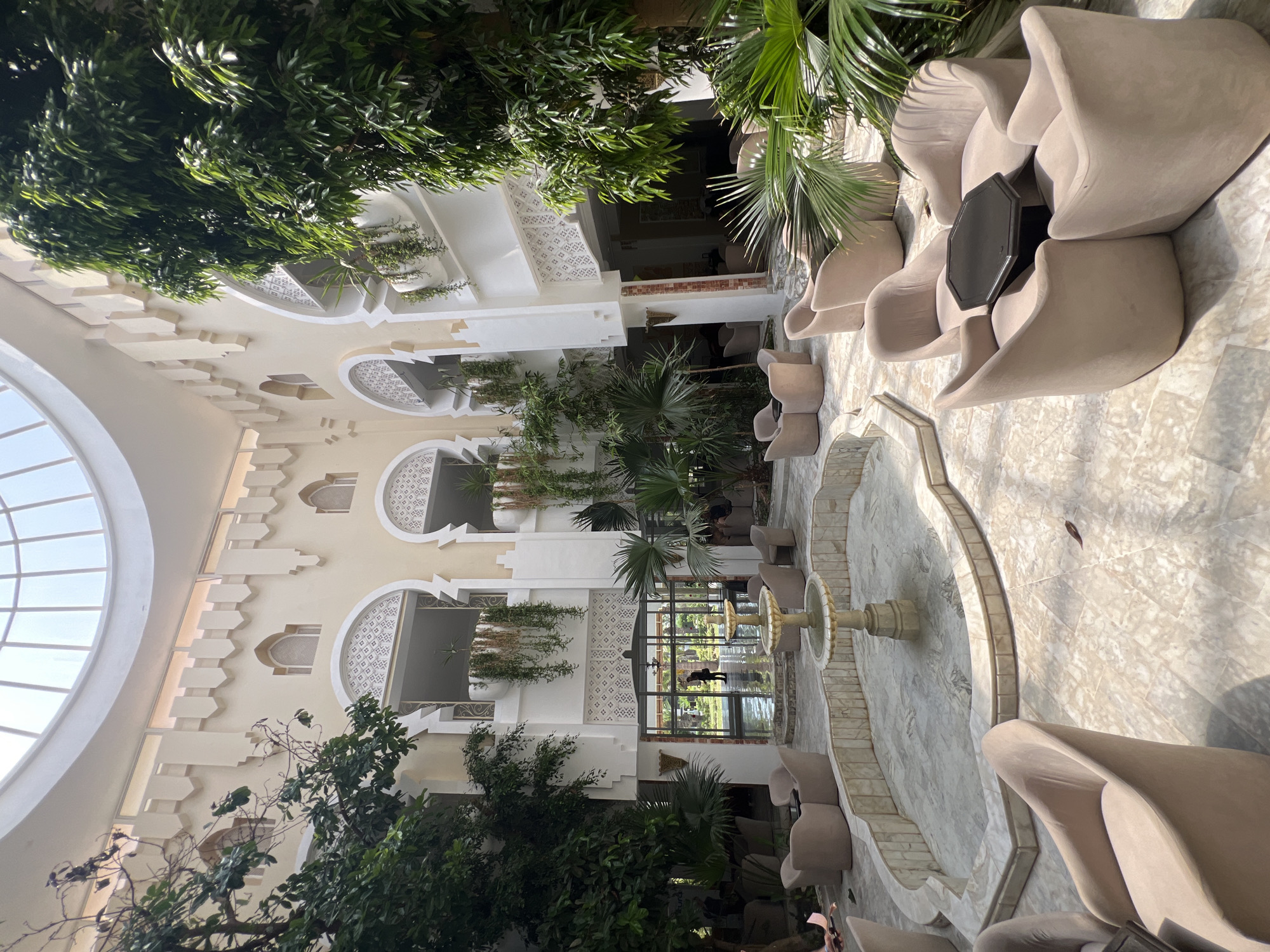 Resort day in Hiboun — pools, courtyards, and date palms