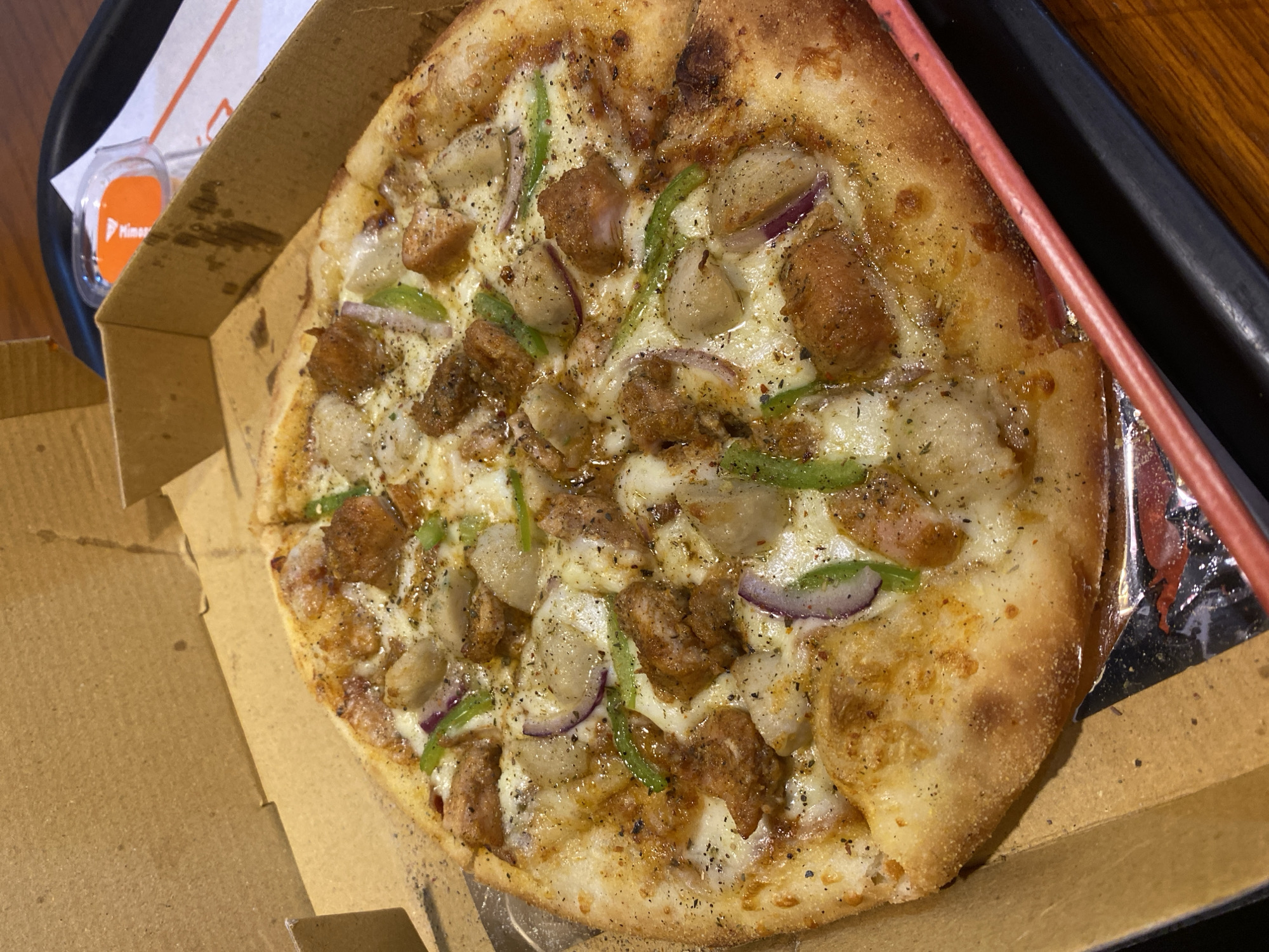 Thick-crust chicken and pepper pizza in Dhaka