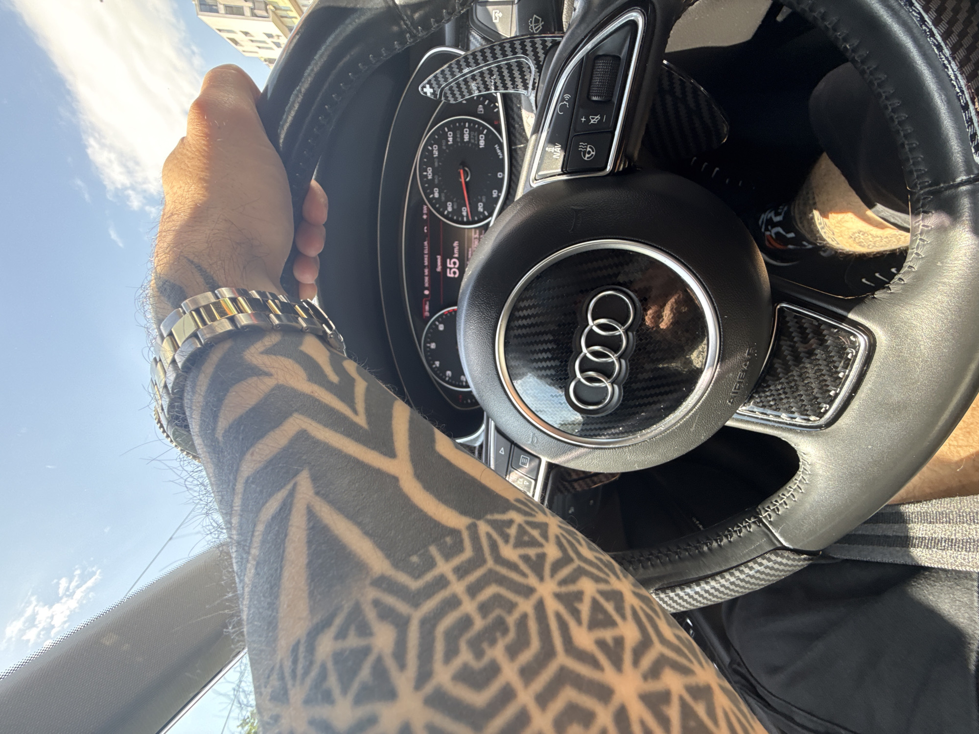 Tattooed driver operates Audi in Sofia morning commute