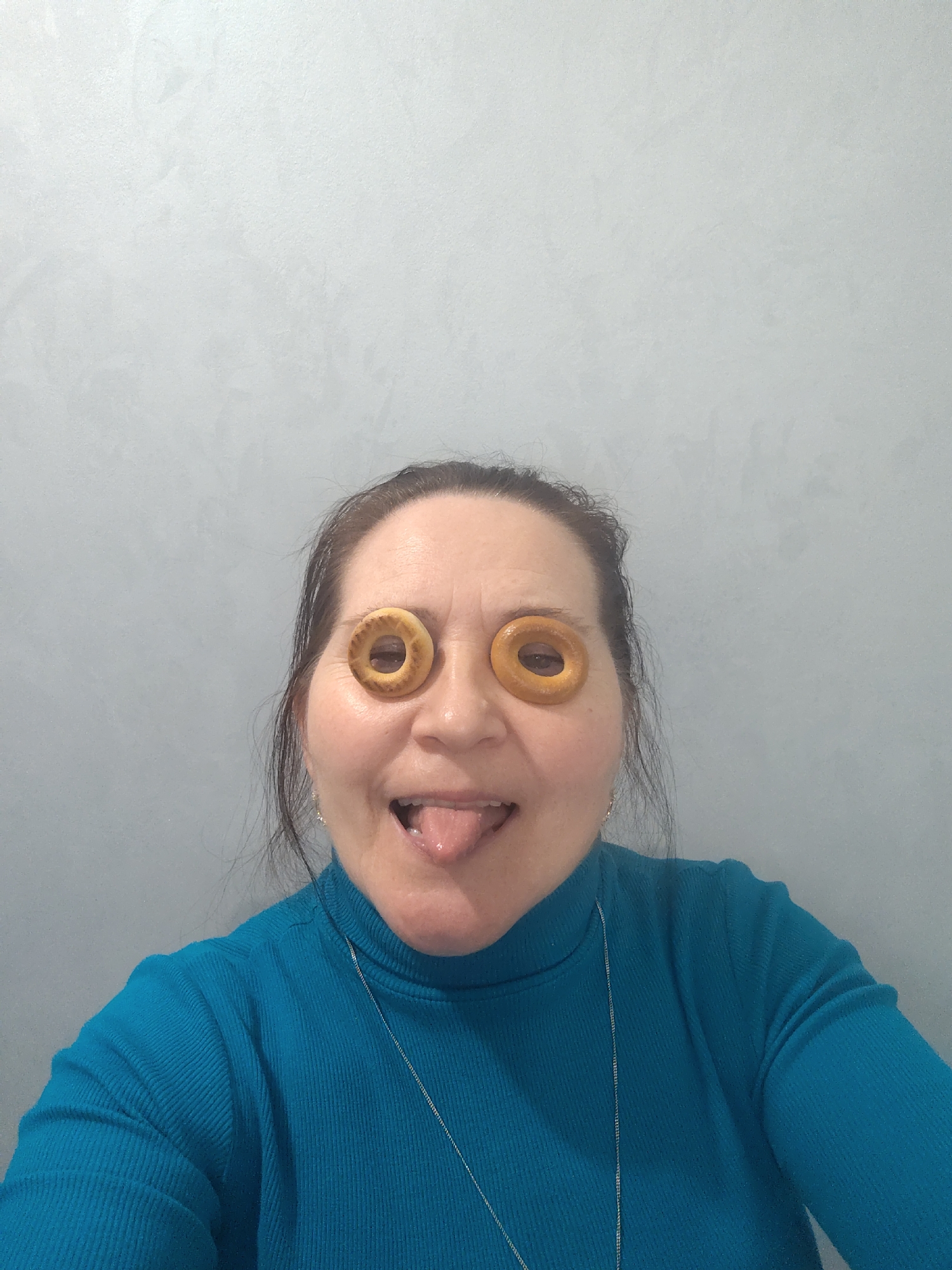 Woman poses playfully with household items in Sarapul indoor session