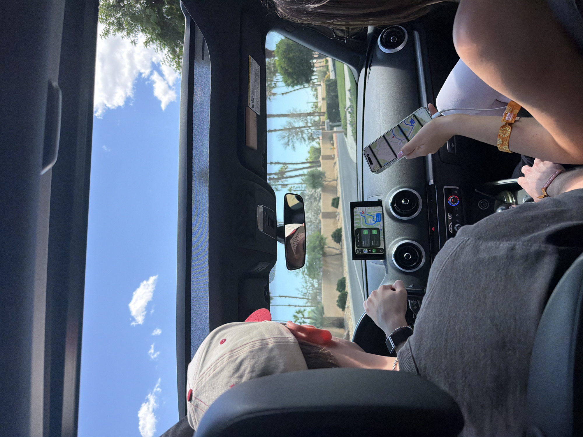 Driver in baseball cap spotted on palm-lined La Quinta street