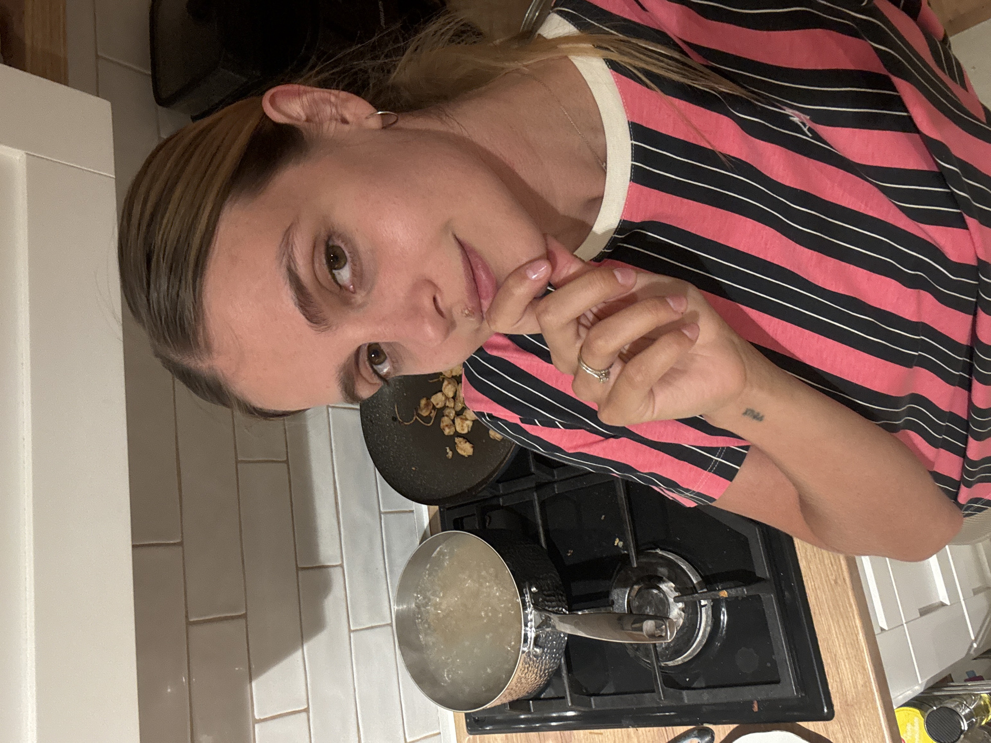 Woman observed near food platter on wooden surface