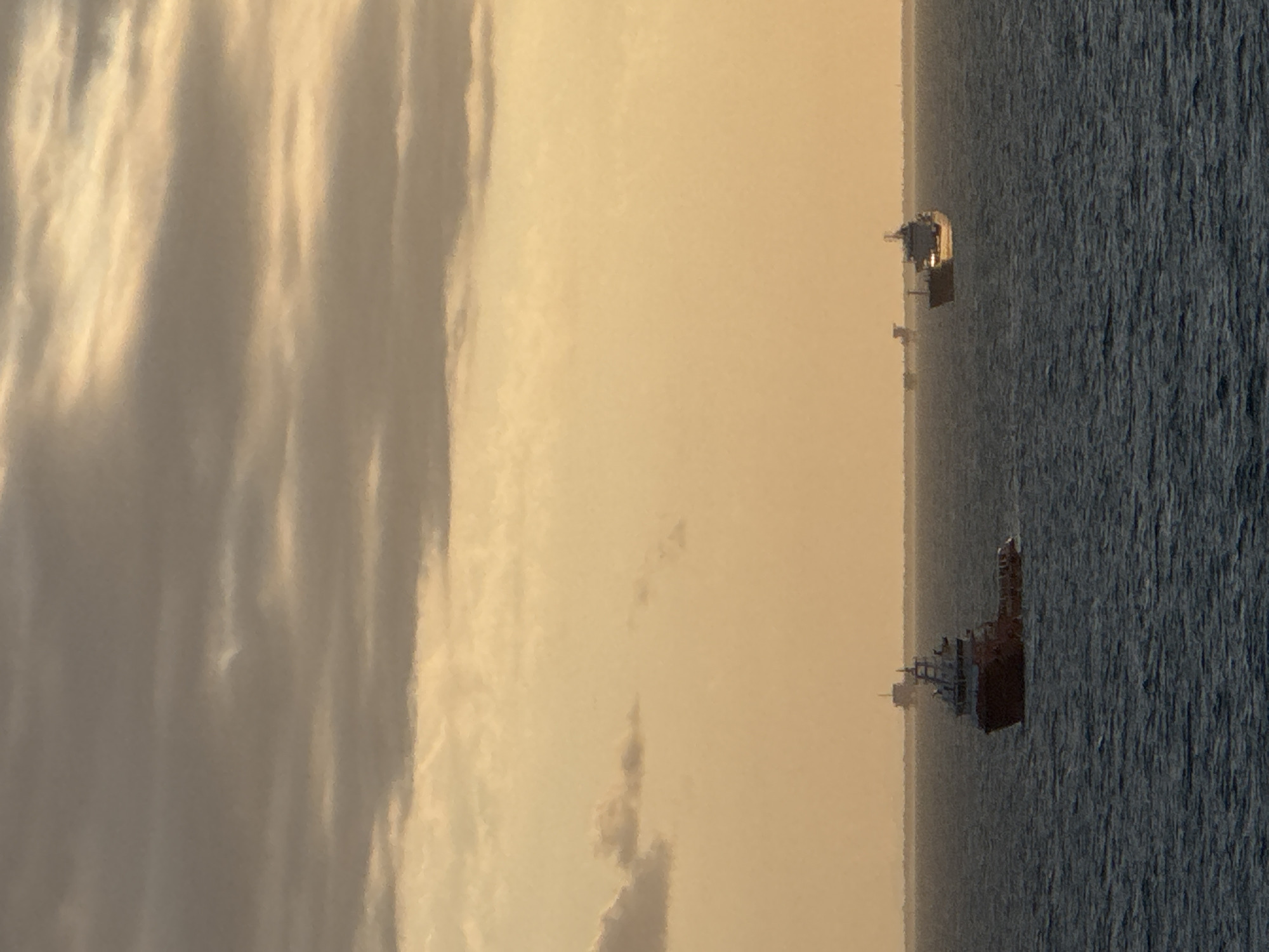 Offshore platform operations documented during sunset in Adriatic Sea