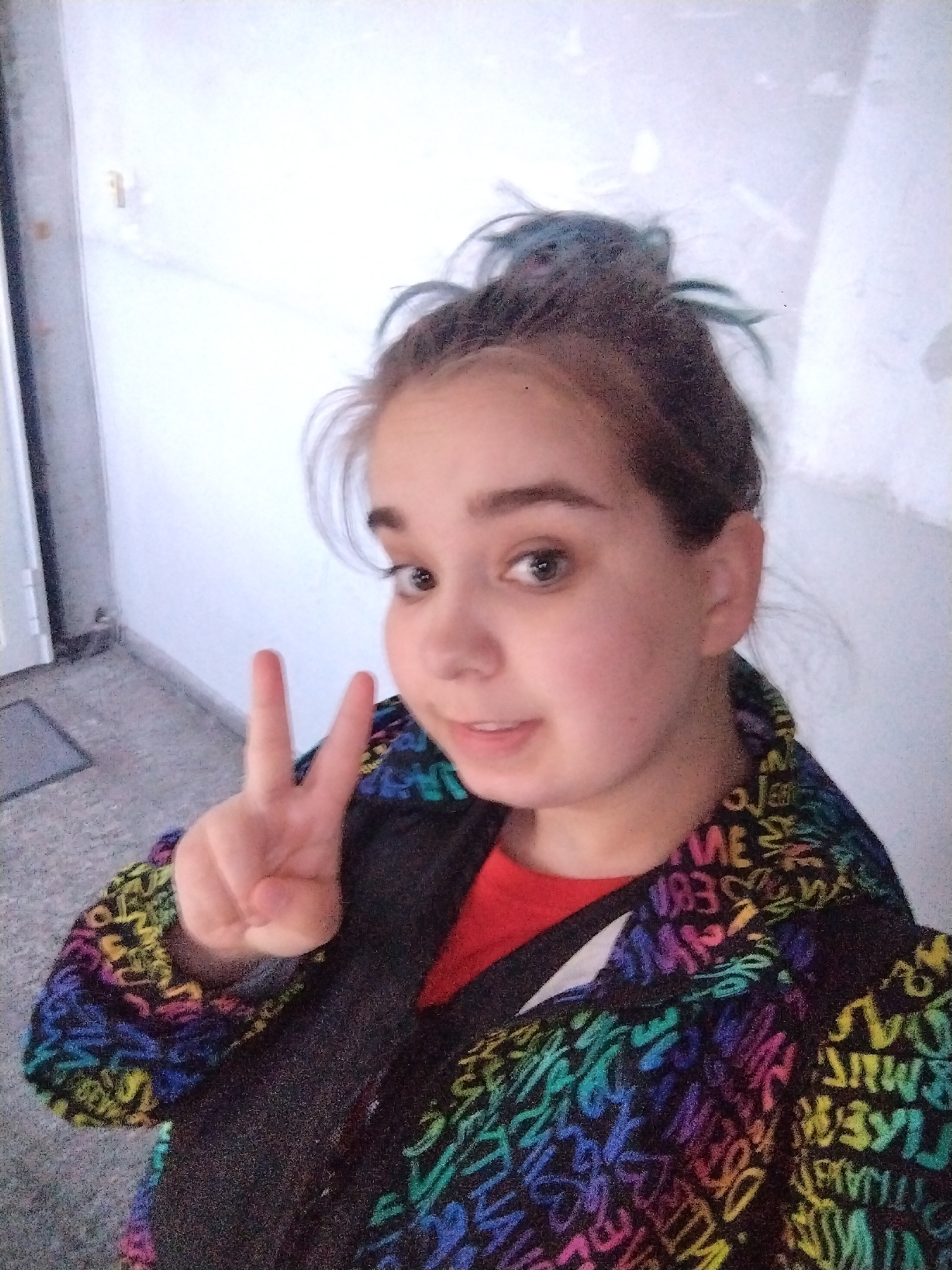 Woman takes playful selfies in Plovdiv hallway early morning