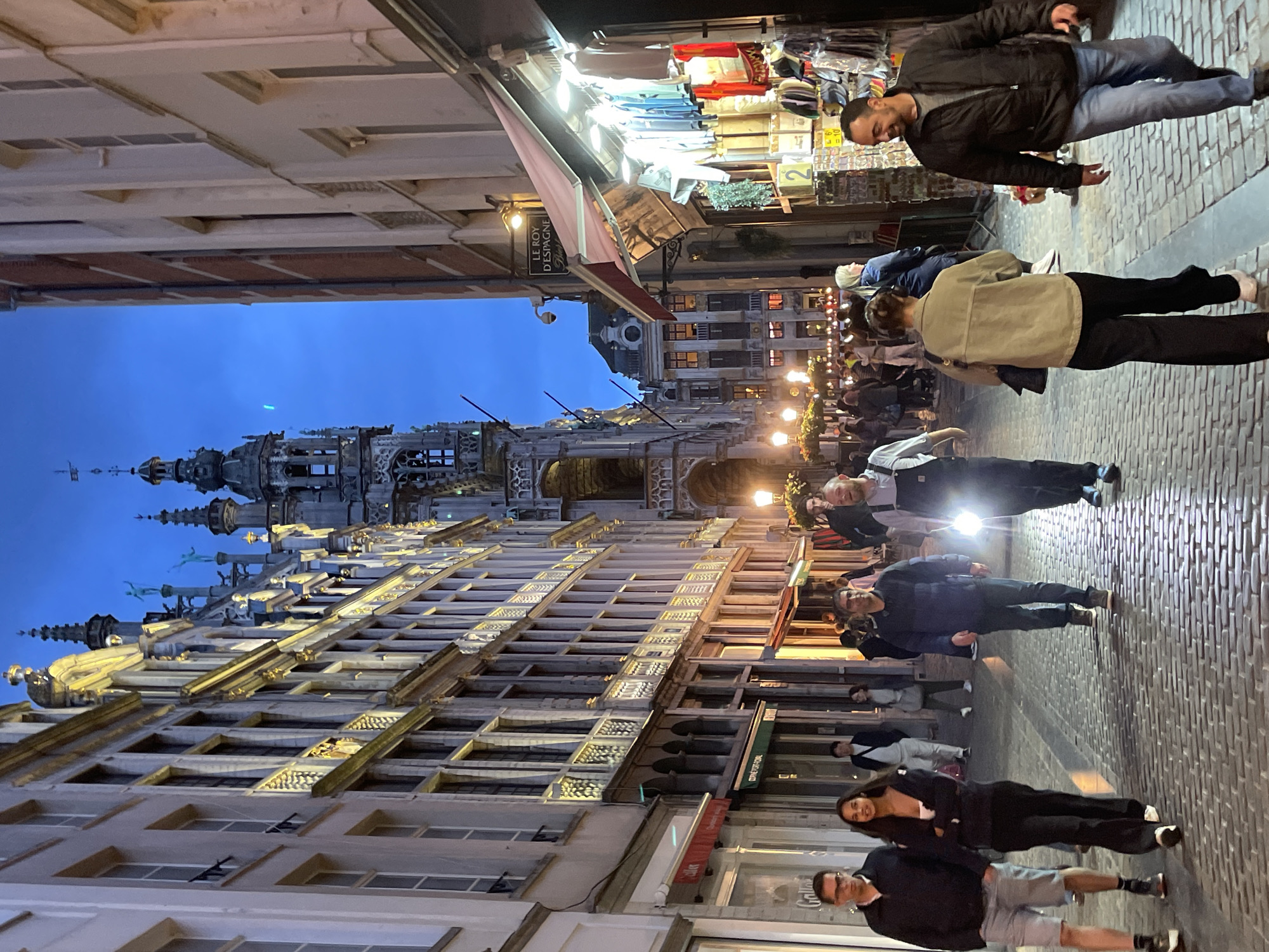 Evening crowds gather at illuminated Brussels Grand Place