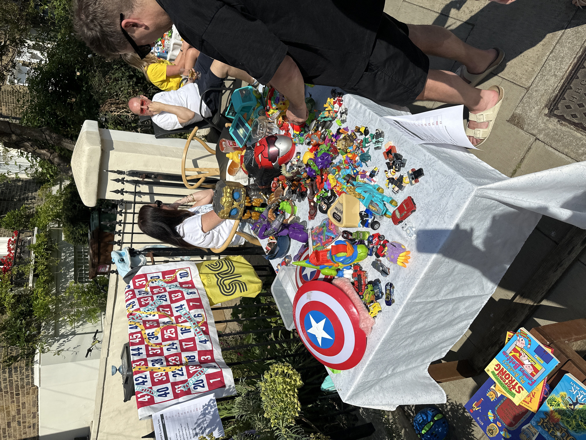 Neighborhood jumble sale held on London residential street