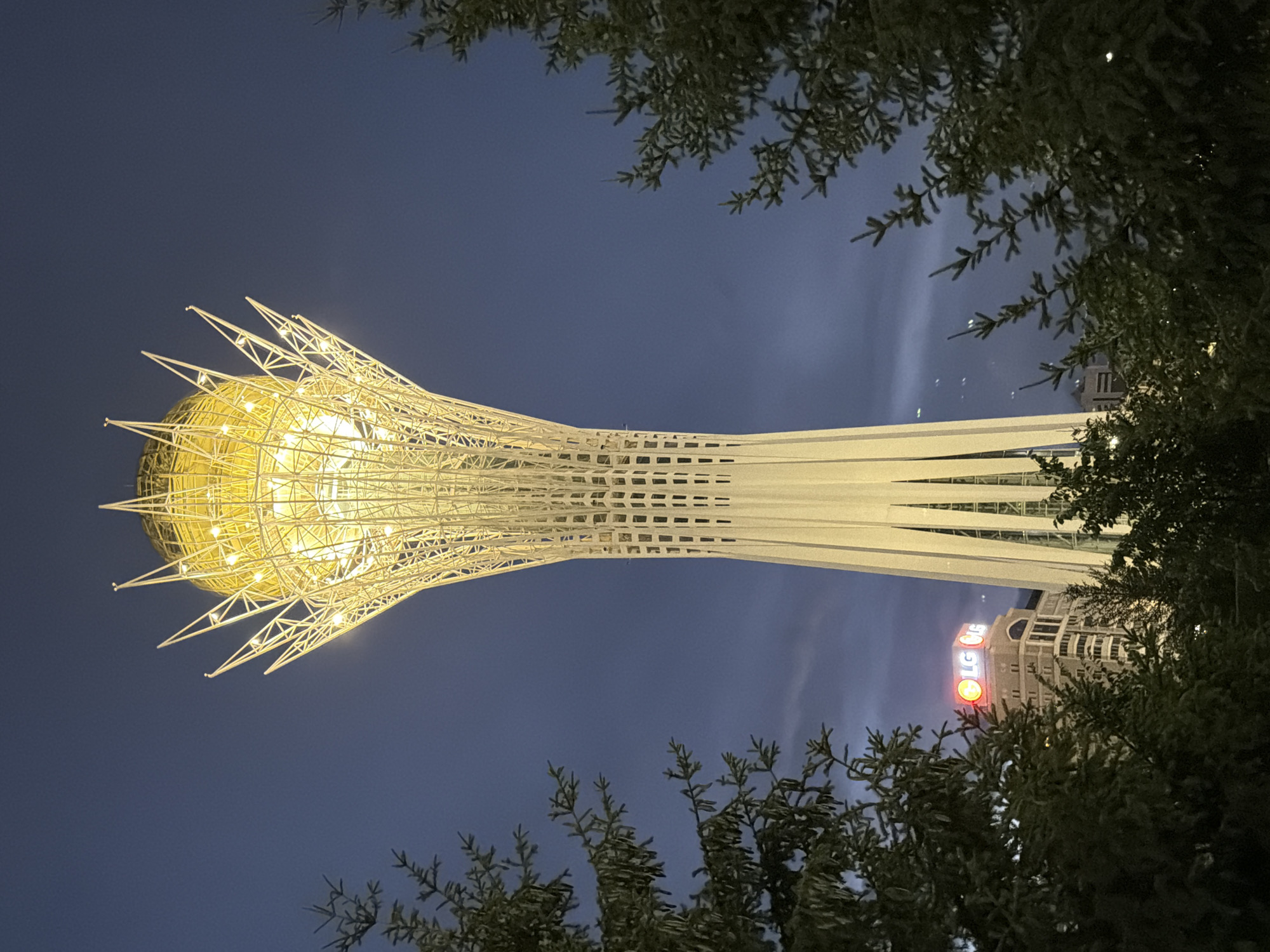 Bayterek Tower and Astana skyline glowing after dark