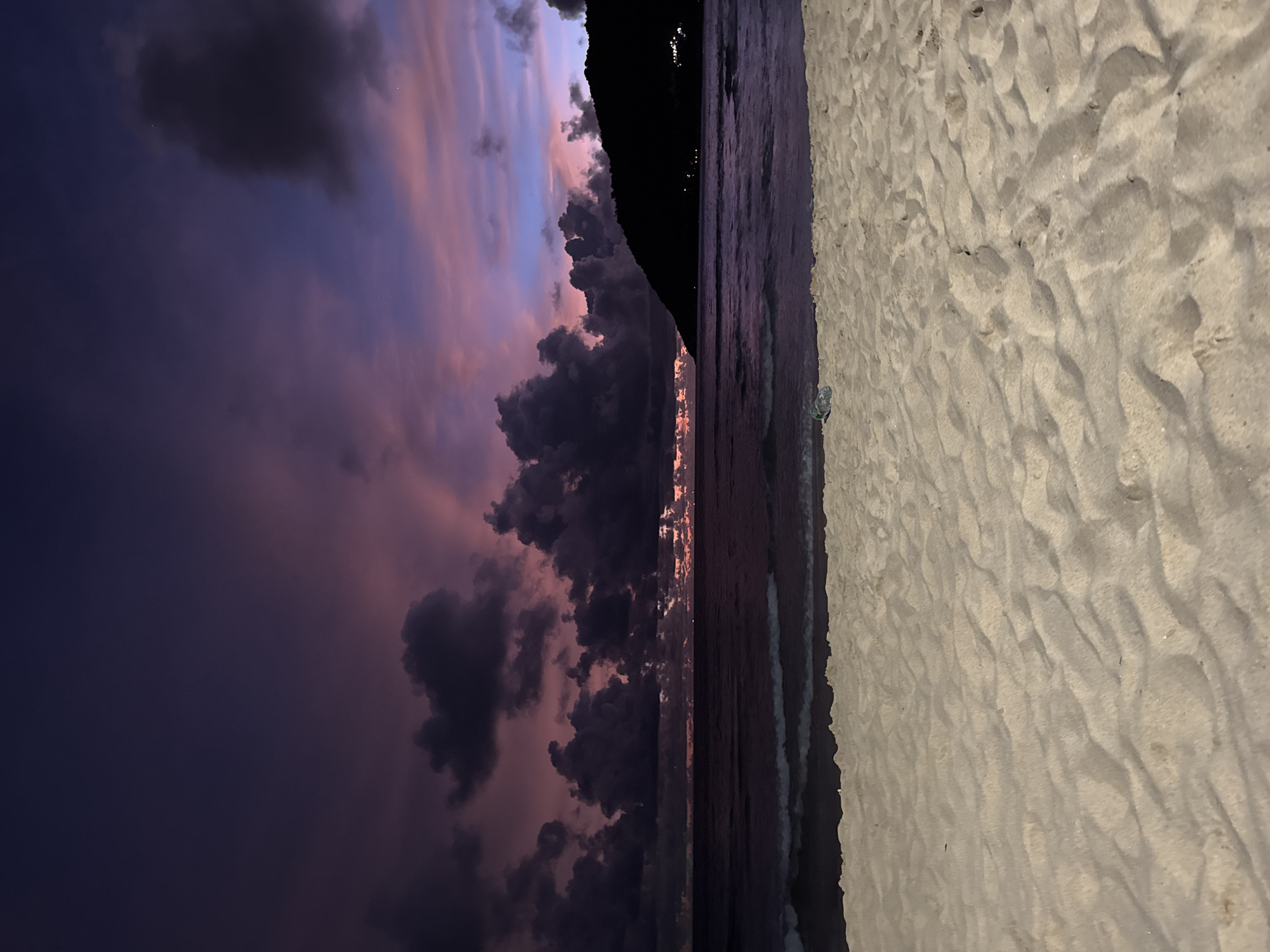 Rawai Beach at golden hour: crowds, stormy skies, good vibes