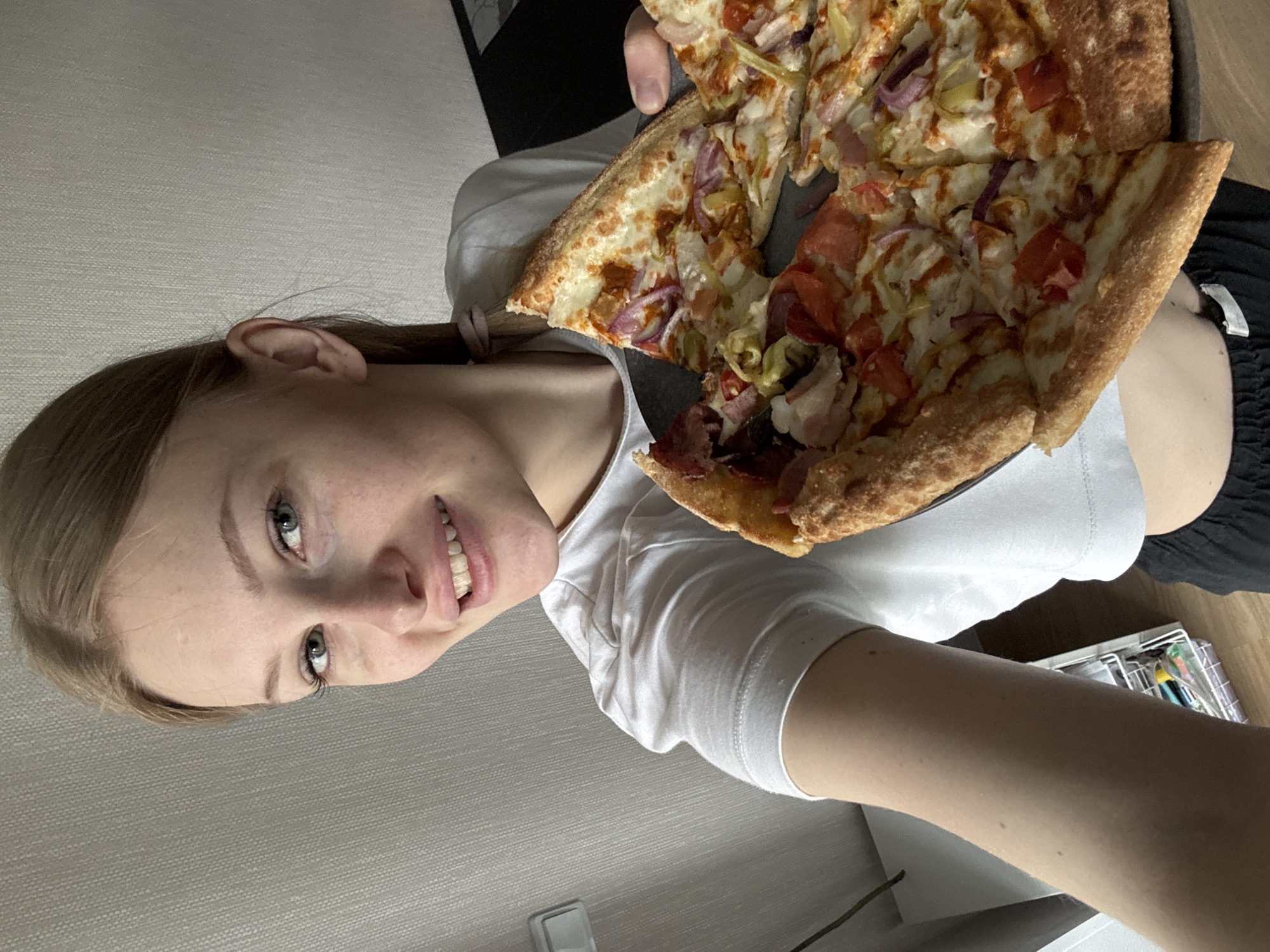 Woman documents morning routine and pizza breakfast in Perm