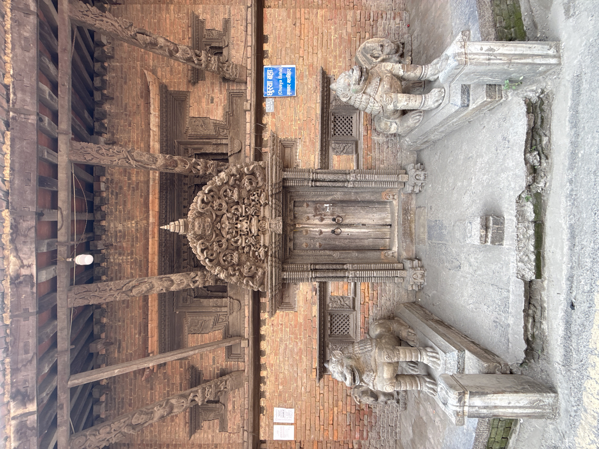 Traditional carved lions guard ornate doorway in Kathmandu
