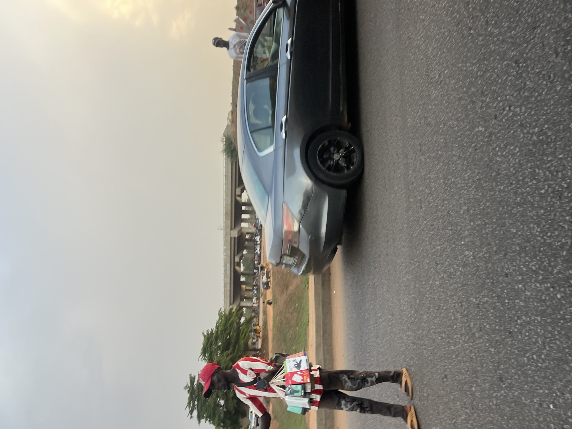 Street vendor sells items roadside near Galadimawa Village, Nigeria