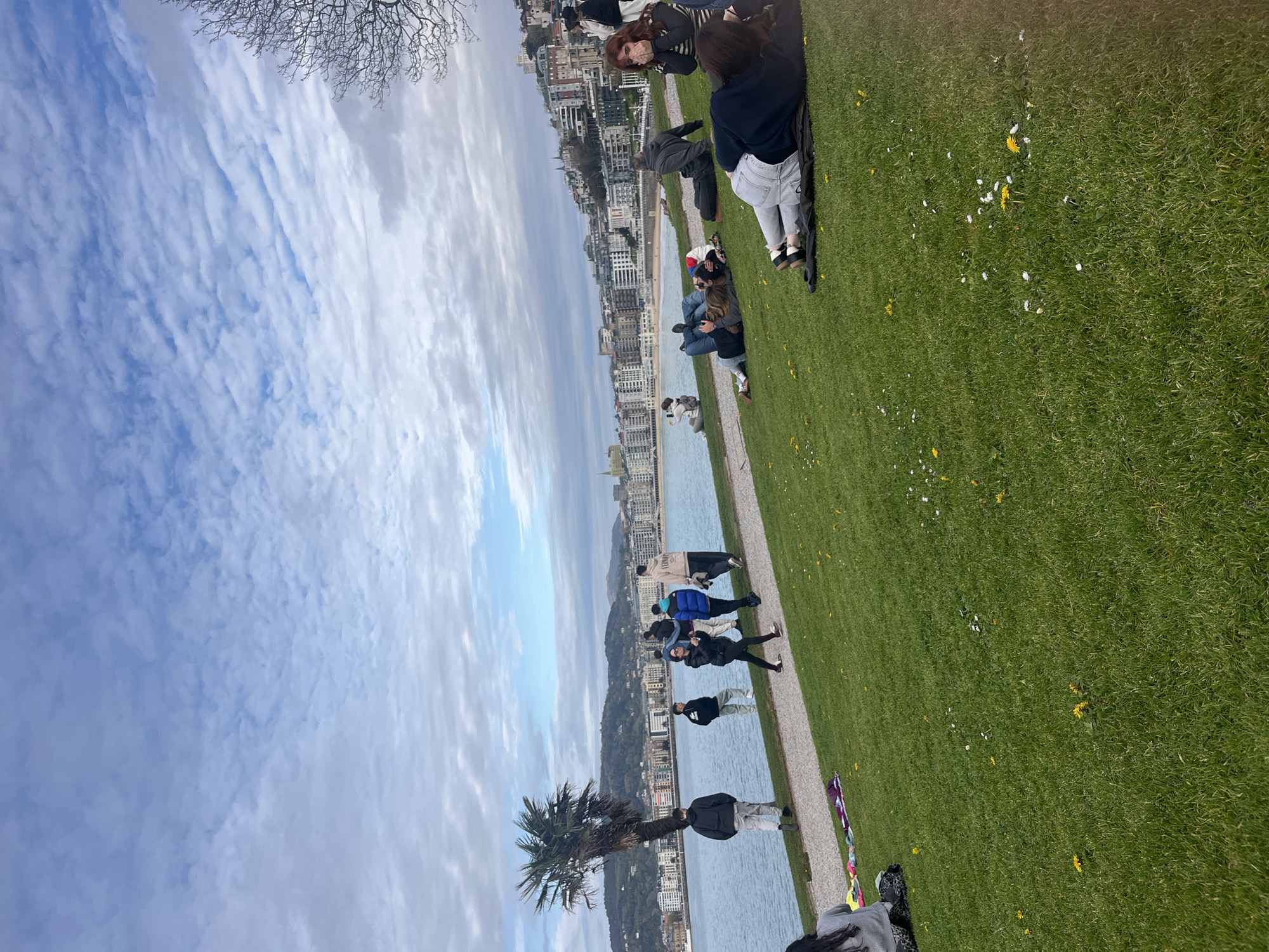 Woman enjoys afternoon rest on San Sebastián coastal grass