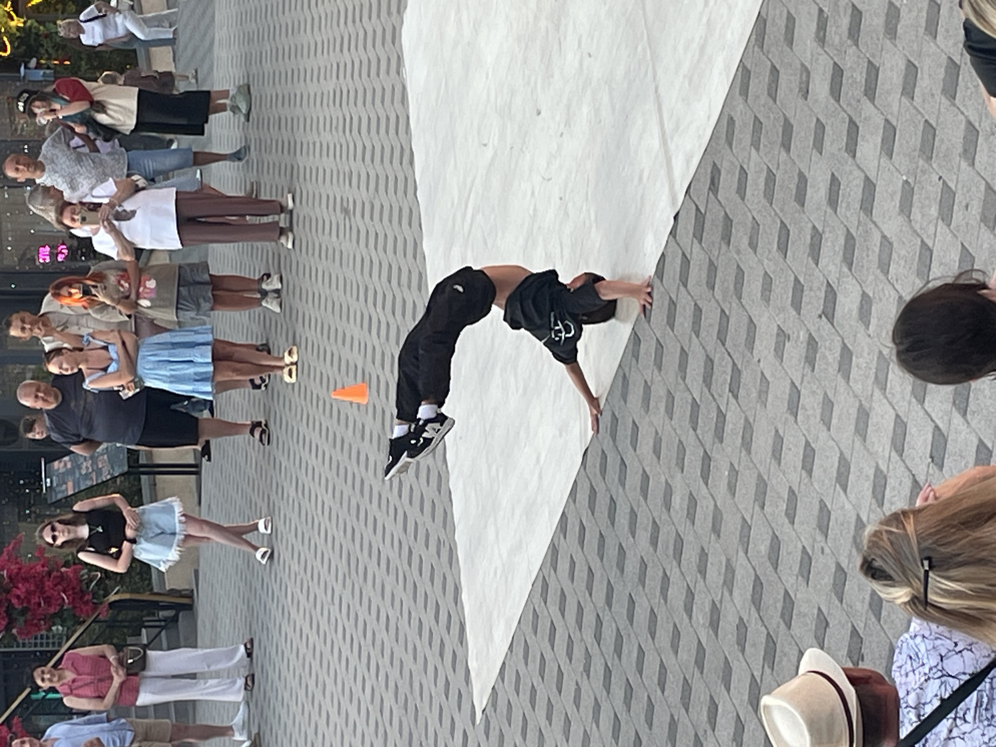 Breakdancing and a harbor sunset on a city evening