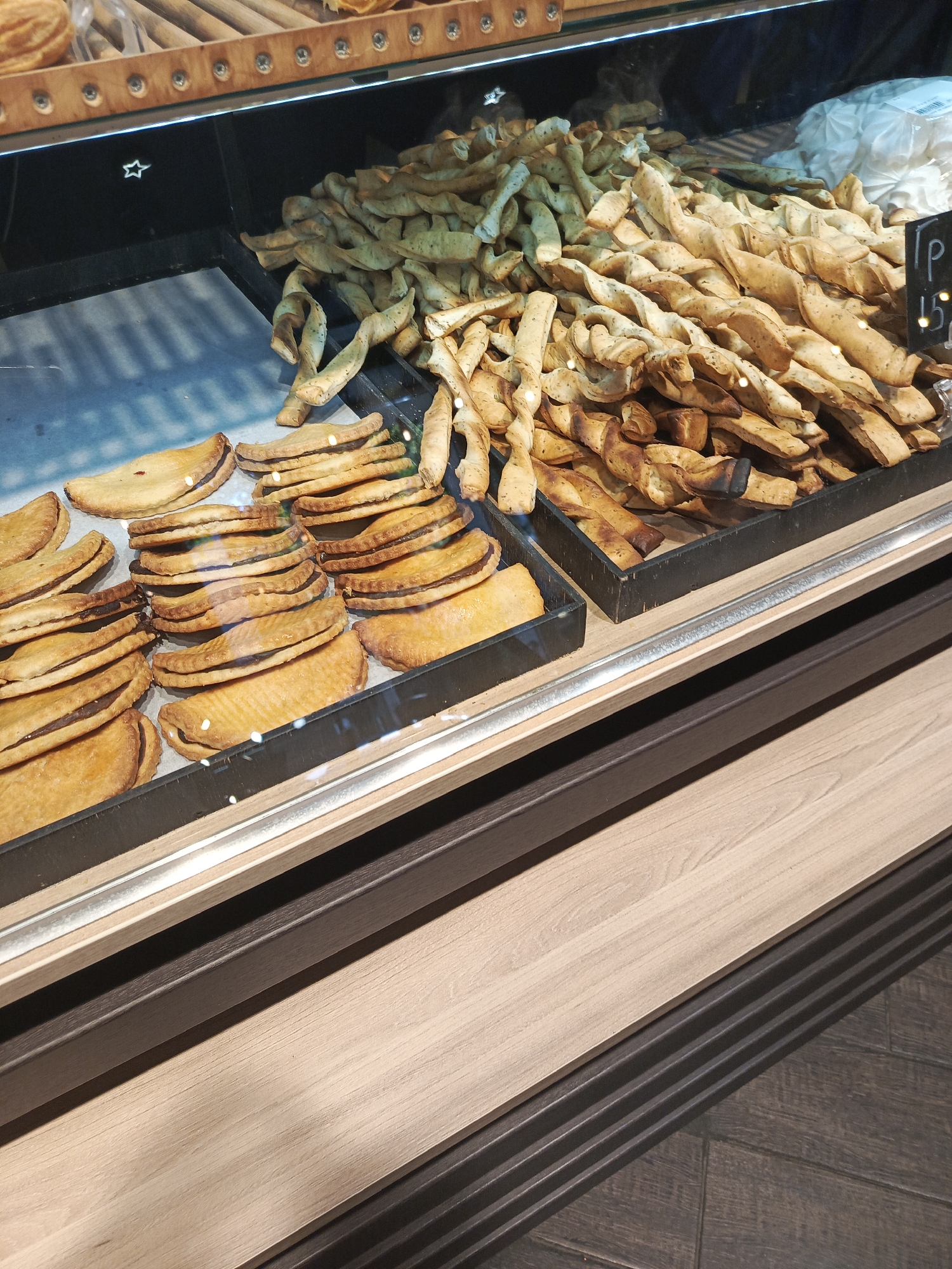 Bakery shelves and a moon-landing mannequin, same morning