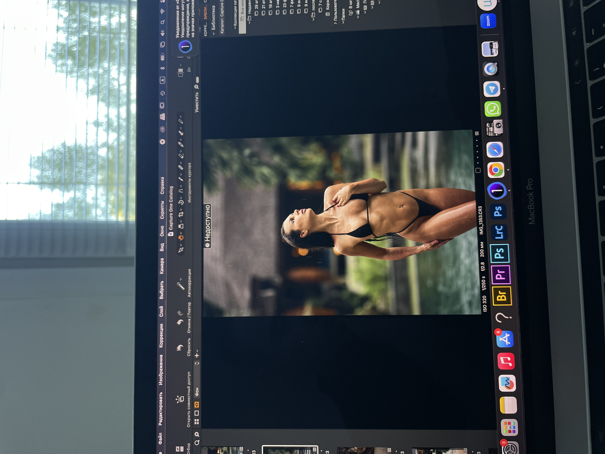 Photographer edits bikini photos in Capture One software in Kazan