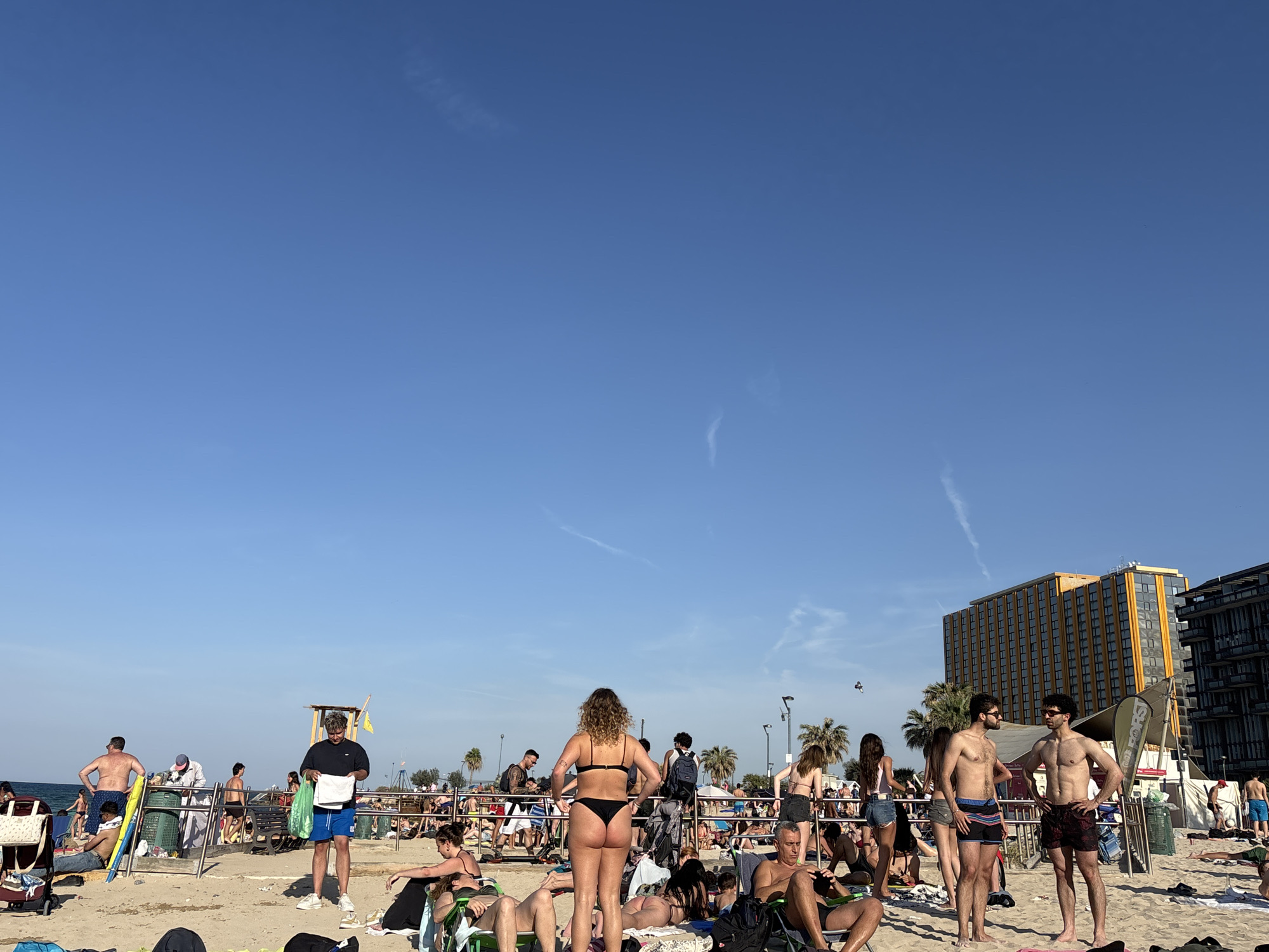 Busy beach and urban scenes documented during sunny afternoon