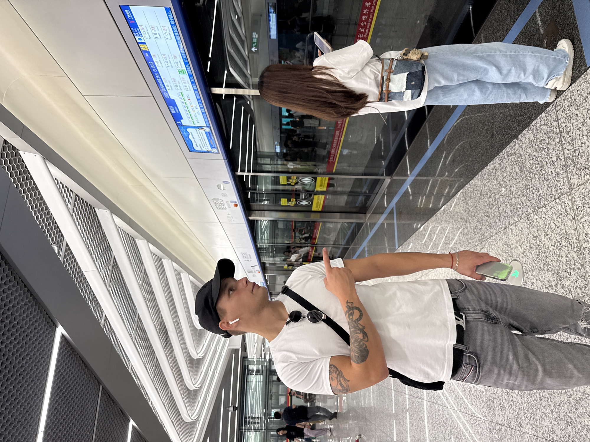 Man travels through Guangzhou metro station making gestures