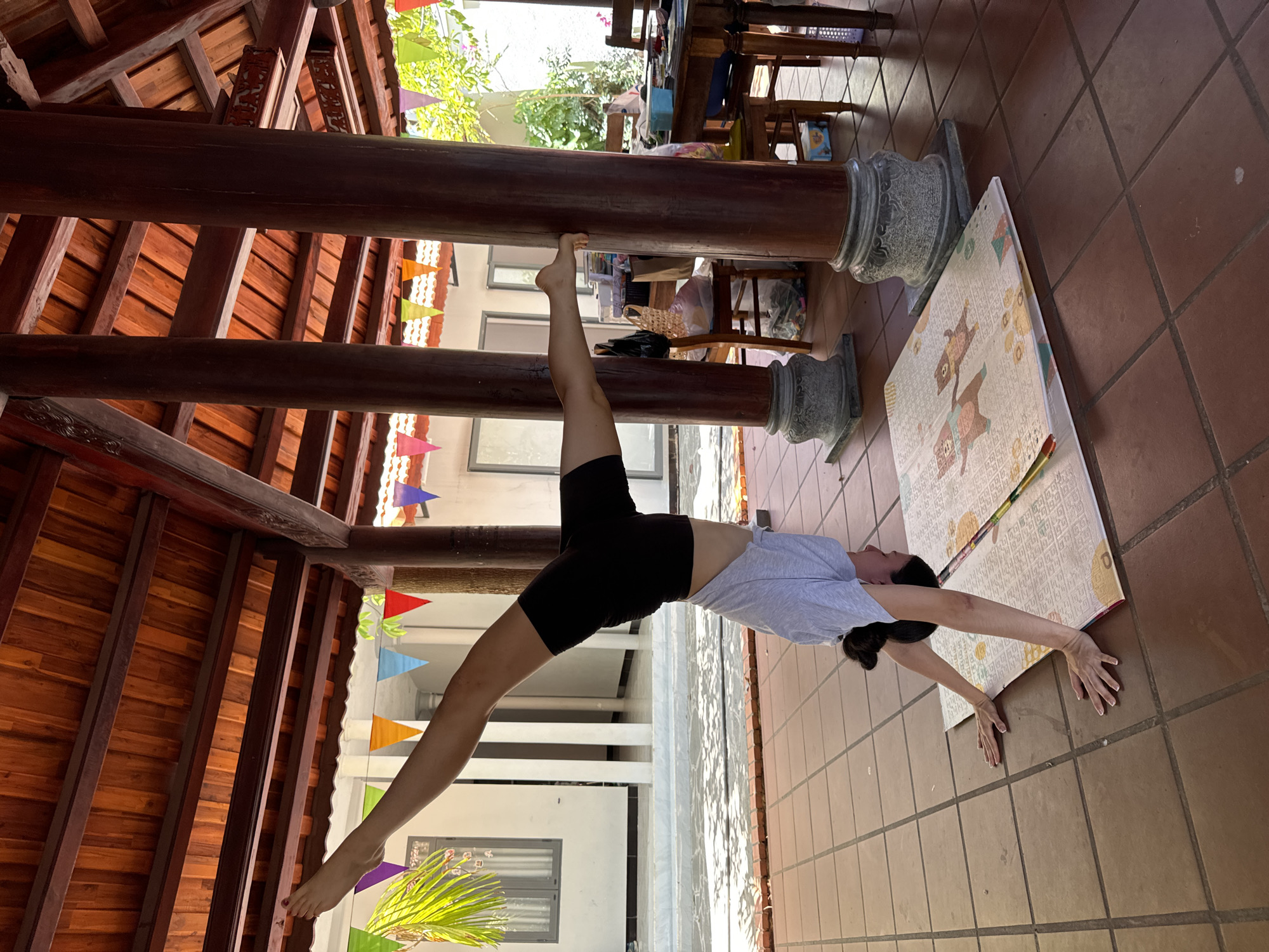 Woman performs early morning gymnastics routine in Mũi Né pavilion