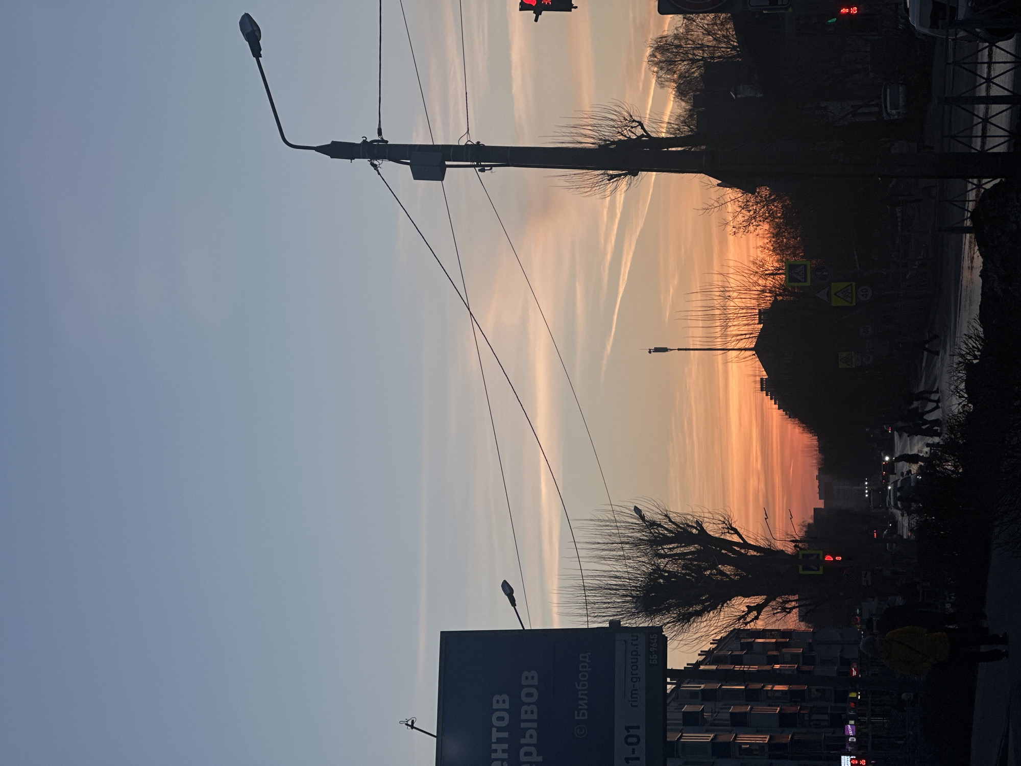 Sunset street scene captured in Kazan with contrails overhead