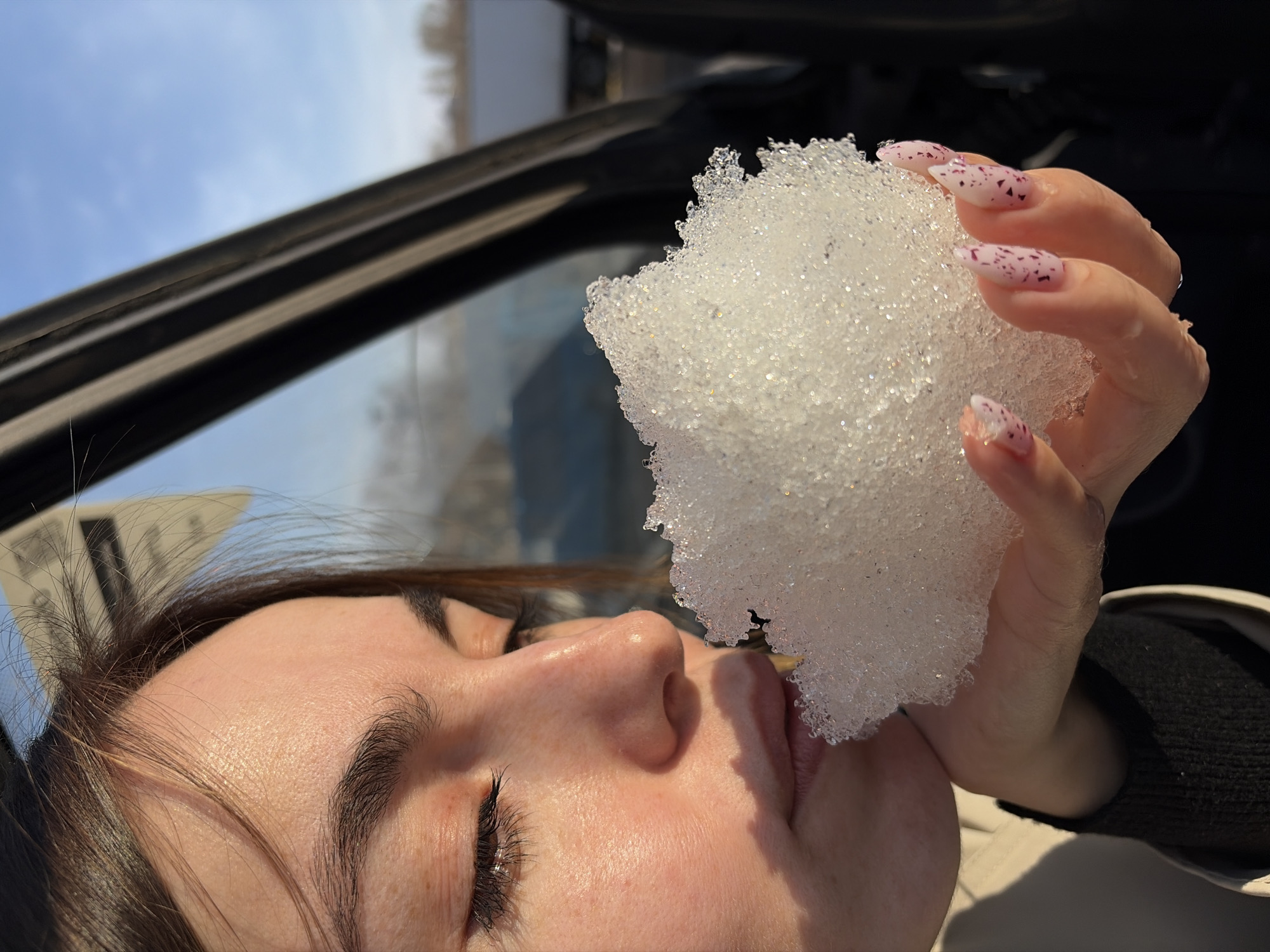 Woman eating snow captured in multiple moments in Izhevsk