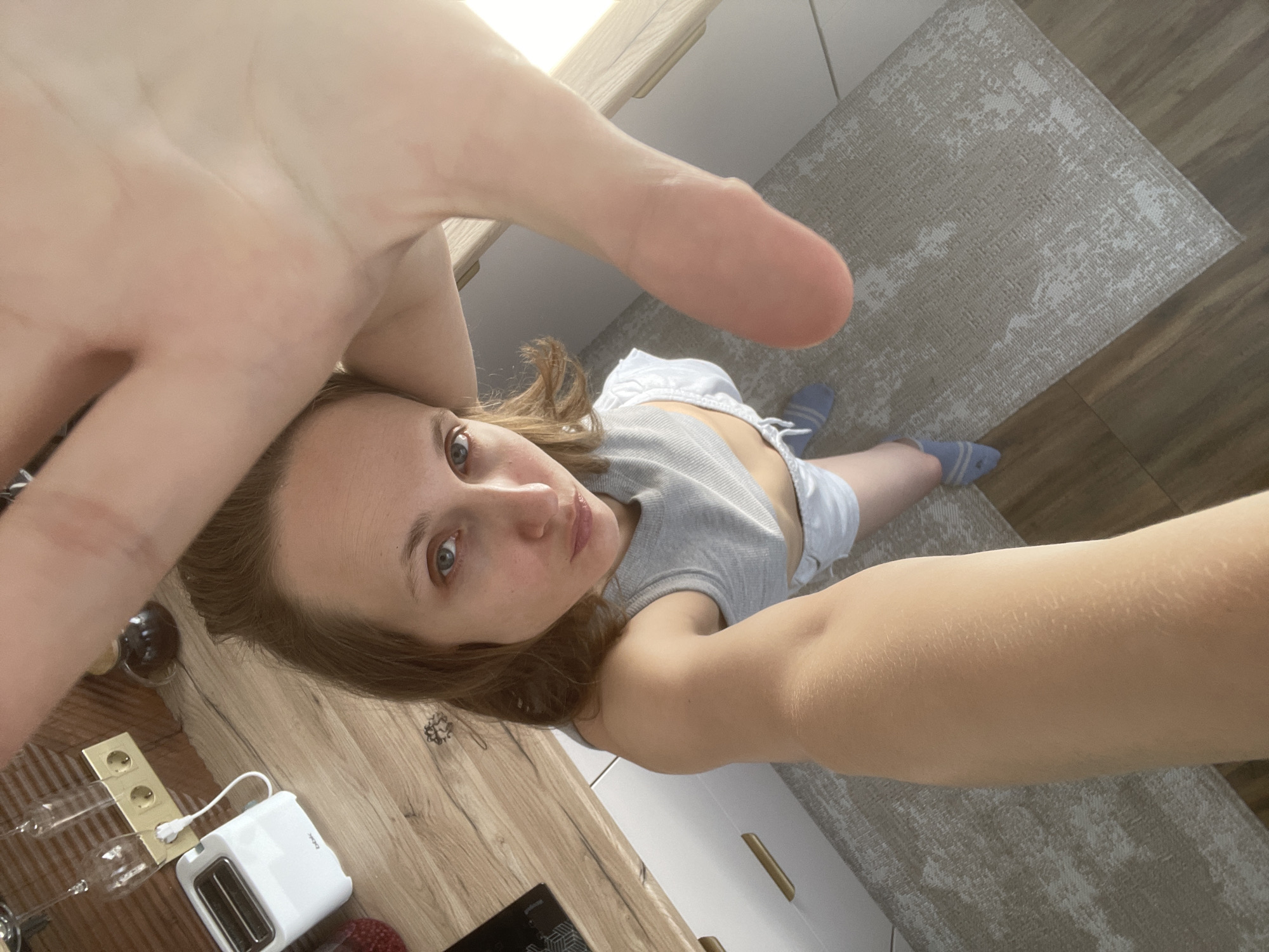Woman Takes Kitchen Selfies in Gray Tank Top